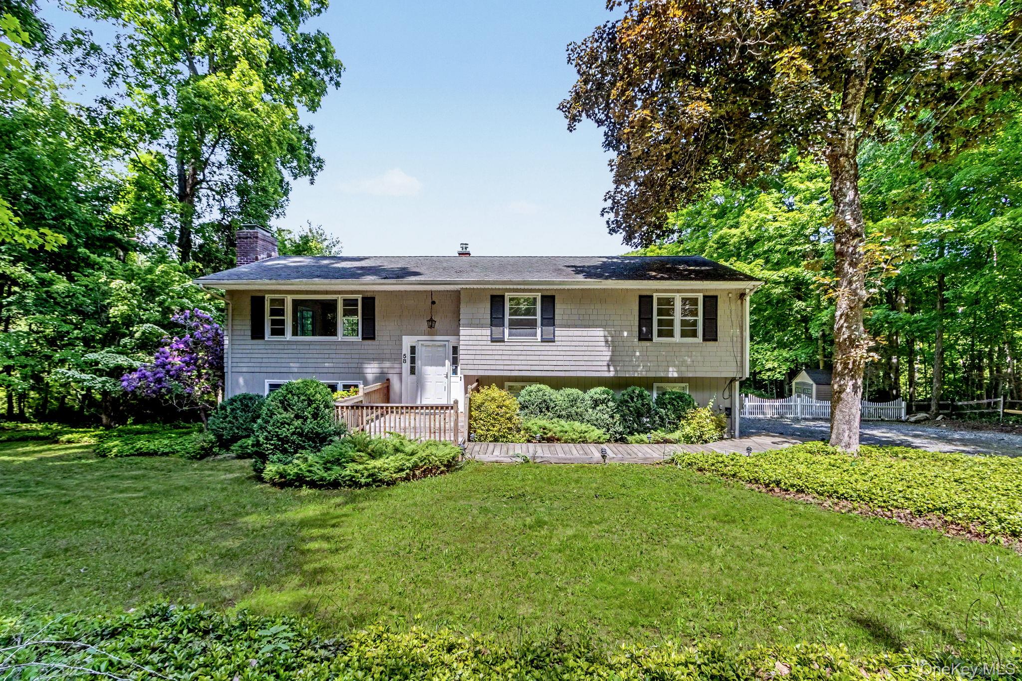 Nestled on a private, picturesque 1-acre property, this move-in-ready home offers the perfect blend of comfort, convenience, and natural beauty. Freshly painted throughout, the home features newly refinished hardwood floors that shine with warmth and character.The spacious interior boasts two fireplaces, creating inviting gathering spaces for every season, while a beautiful bay window fills the home with natural light and frames peaceful views. The updated kitchen is equipped with stainless steel appliances, including a recently replaced dishwasher and microwave, making everyday living both stylish and practical.The primary suite offers a generous walk-in closet, and central air conditioning ensures year-round comfort. For added peace of mind, the home is generator-ready and includes a spacious two-car garage.Step outside and enjoy the stunning wraparound two-tier deck, perfect for entertaining, dining al fresco, or simply relaxing while taking in the seasonal water views and serene surroundings. A charming white fence enhances the property's curb appeal and sense of privacy.Ideally located just off Route 35, this exceptional home offers easy access to the Goldens Bridge Metro-North station on the Harlem Line, providing a convenient commute to New York City. The station also offers ample parking, making travel effortless.With its private setting, thoughtful updates, and desirable location, this beautifully maintained home is ready for its next owner to move right in and enjoy. Enjoy Seasonal lake views.