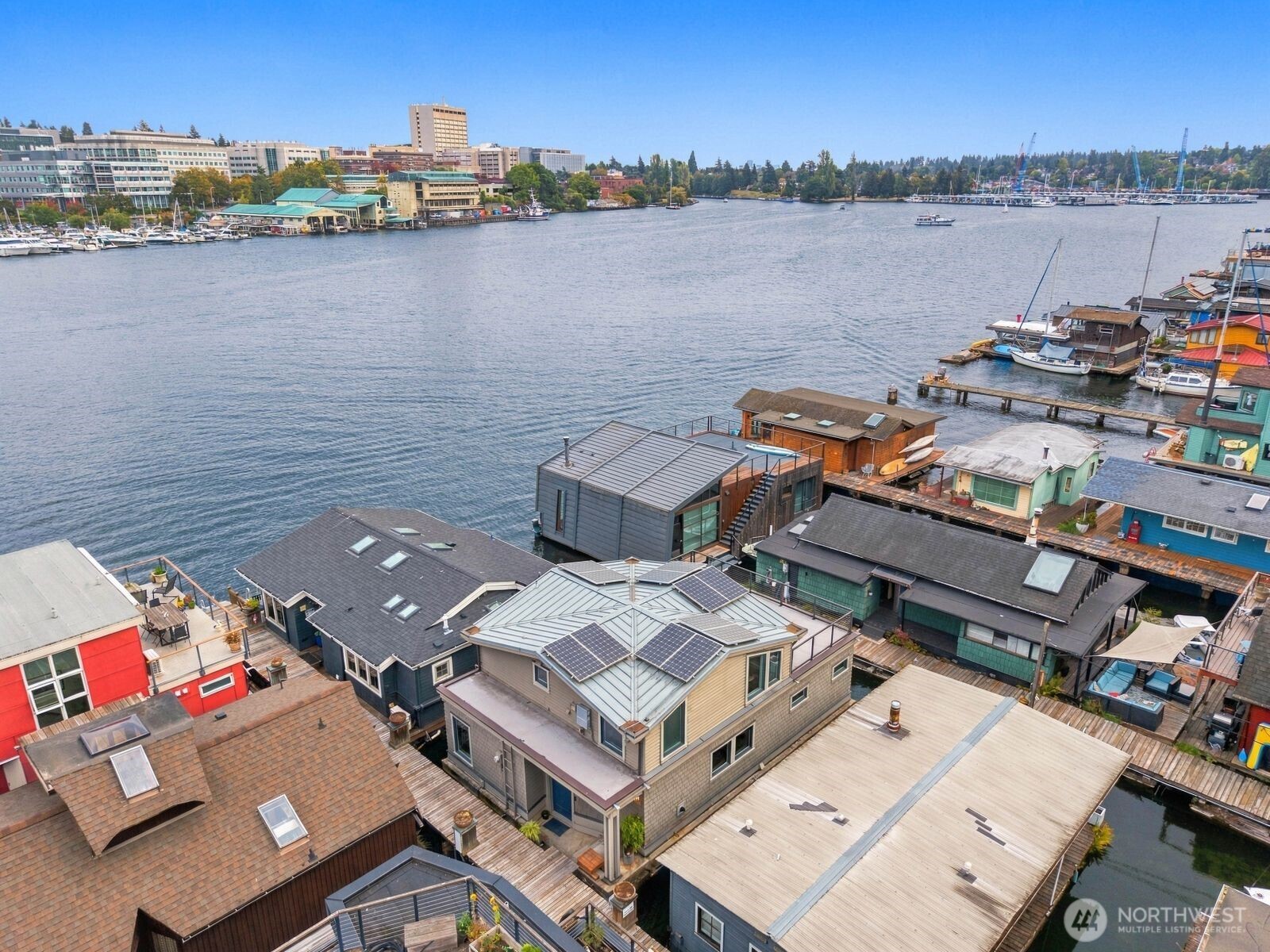 Discerning buyers will take note of this beautifully designed AIA Architecture from Lagerquist & Morris residing in a slip second to the end of this condo owned dock.  Elegant vaulted fir ceilings and large windows facing the waterway create a harmonious theme of peace and tranquility.  The protected southeast view corridor is priceless.  This energy efficient 3 bed, 2 bath home has radiant in-floor heating, a gas fireplace and solar power.  Rarely seen TWO 53 sq ft storage units on shore and equally rare on a floating home community, a lawn to enjoy a picnic or start your passion gardening project. One convenient reserved parking space provided with EV capability.  Portage Bay residents enjoy a quietly private lifestyle on the waterfront with the perks of being among an exclusive community of historic 507 floating homes available in Seattle.