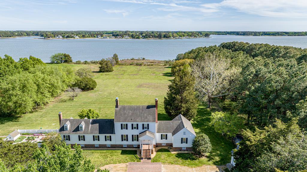 Timeless Waterfront Estate on 22.1 Acres. Set on Virginia's Eastern Shore, “Andua” offers an extraordinary combination of historical charm, natural beauty, & expansion potential. With approximately 2,500 feet of sandy waterfront & a deep-water dock with a boat lift, the property is ideal for those who appreciate both legacy & lifestyle. Protected by a conservation easement which allows for expansion of the main home & the addition of a pool—offering rare flexibility for a property of this stature. The interior features a commercial-grade kitchen, first-floor primary suite, 2 additional bedrooms (plus a bonus room), & attic storage. Outside, enjoy a 3-car detached garage, a 4-bay metal barn large enough for boats & equipment, & beautifully designed gardens with boxwoods & walking paths.
