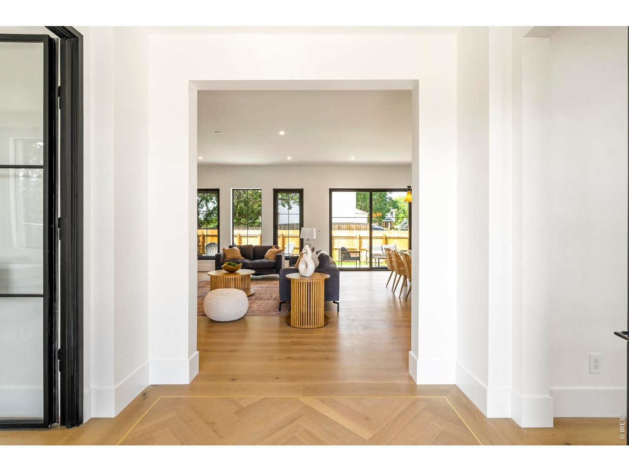 Set on a quiet cul-de-sac in the heart of Louisville, this completely new residence pairs elevated craftsmanship with sophisticated modern style. An expansive open layout unites the kitchen, dining and living spaces beneath 10-foot ceilings, with white oak floors and custom cabinetry creating a refined backdrop for everyday living and entertaining. The kitchen is distinguished by Taj Mahal countertops and backsplash, a generous walk-in pantry and premium Kohler fixtures, while 12-foot sliding glass doors extend the living space to a private patio and professionally landscaped backyard. Upstairs, four bedrooms and a conveniently located laundry room create an ideal, functional layout. The remarkable primary suite features vaulted ceilings, a spa-inspired en-suite bath with a sauna and an expansive walk-in closet. A spacious main-floor office, finished basement with a second living area, six total bedrooms and a three-car garage provide exceptional versatility. Multi-zoned heating and cooling complete this exceptional home just minutes from Louisville's Main Street, shops, schools and parks.