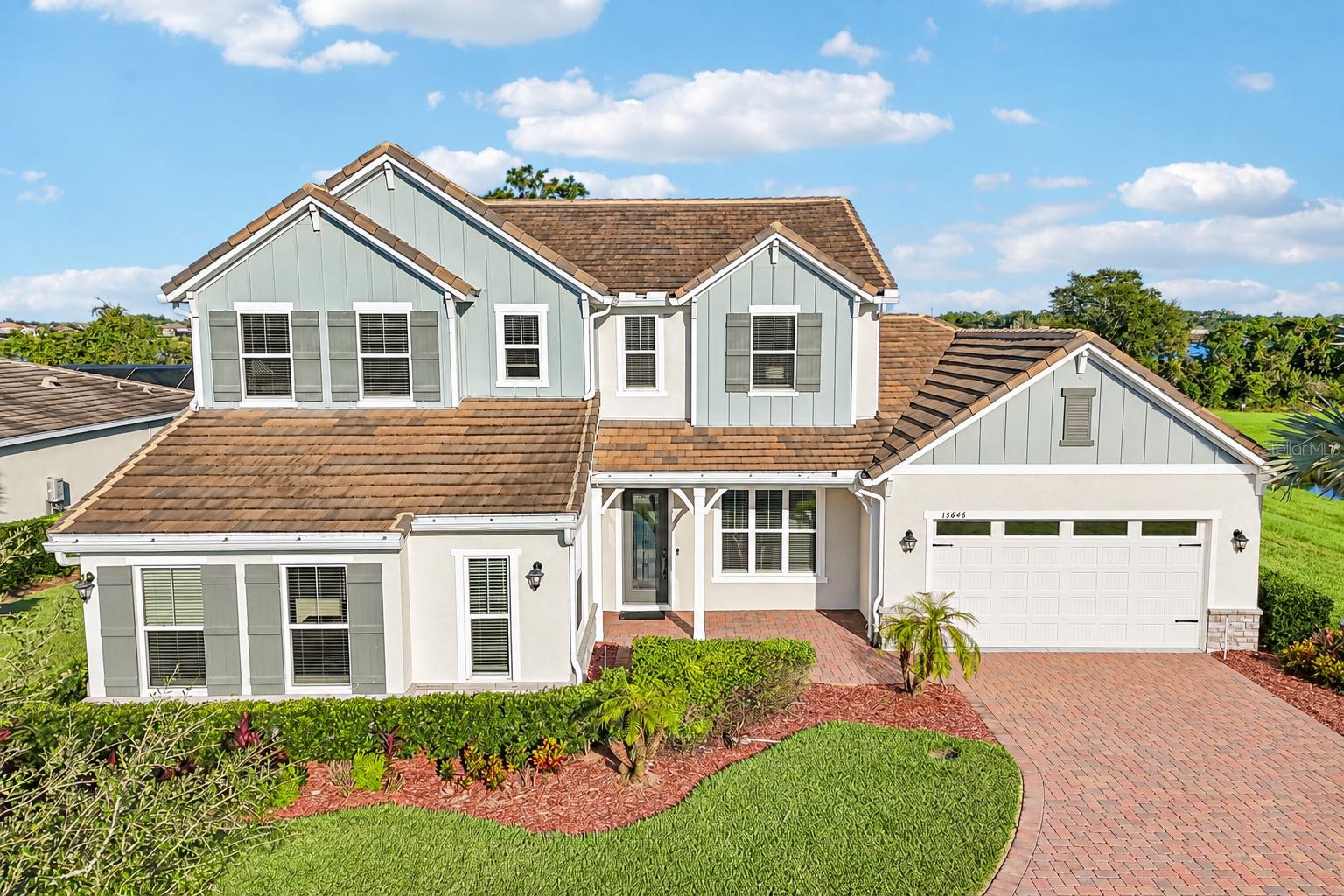 LAKEFRONT LUXURY, a PRIVATE POOL, and room to grow in sought-after Winter Garden! BUILT IN 2021, this beautifully upgraded 5-bedroom, 3.5-bath home sits on an OVERSIZED .37 ACRE CUL-DE-SAC LOT overlooking LAKE HUCKLEBERRY in the Highlands at Summerlake Groves community. Surrounded by WOODED, LAKE, and POND VIEWS with minimal neighbors, this property offers a rare sense of privacy while keeping everyday conveniences close by. Lake Huckleberry is a 150-ACRE SKIABLE LAKE, and the county has approved a private dock to be built, opening the door to enjoying lake life right from your backyard! Beautiful landscaping, a PAVER DRIVEWAY, and inviting curb appeal welcome you home to a light-filled interior where thoughtful design meets comfortable luxury. Large-format MARBLE-LOOK TILE flows diagonally throughout the main living areas, complemented by crown molding, upgraded lighting, and elegant finishes. The OPEN CONCEPT living spaces are designed for effortless entertaining, with wide sliding glass doors connecting the indoors to the COVERED LANAI and SCREENED POOL. At the heart of the home, the UPGRADED GOURMET KITCHEN impresses with timeless cabinetry, glass-front display cabinets, crown molding, elegant countertops, a large ISLAND with seating, decorative tile backsplash, BUILT-IN GAS COOKTOP, stainless steel range hood, and statement pendant lighting. Your MAIN FLOOR PRIMARY SUITE offers a private retreat with a spacious en-suite bath featuring a double vanity and huge glass-enclosed, custom-tiled WALK-IN SHOWER with a built-in bench and rain shower head. Flexible living spaces include a formal dining area, FLEX/FAMILY ROOM, and an additional OFFICE or MAIN FLOOR BEDROOM converted from the original single-car side-load garage, ideal for working from home or creating a space that fits your needs. A PROFESSIONAL-GRADE ARAKNIS ROUTER AND WHOLE-HOME WI-FI SYSTEM keep you connected throughout the home. A custom BUILT-IN MUDROOM/DROP ZONE adds everyday convenience, while decorative iron staircase balusters, wood handrails, crystal-style chandeliers, and window blinds throughout bring character and style. Outside, your backyard feels like a private resort! Relax under the covered lanai, cool off in the sparkling pool with mosaic tile detailing, or entertain on the expansive paver deck, all within a screened enclosure featuring PANORAMIC SCREEN PANELS that showcase the lake and peaceful natural surroundings. A 6-FOOT BLACK ALUMINUM FENCE surrounds the side and rear yards, defining the outdoor space while preserving the open views. Located in the Highlands at Summerlake Groves, this home offers easy access to SR 429, shopping, dining, and all that Winter Garden has to offer, with sought-after A-RATED SCHOOLS – Summerlake Elementary, Hamlin Middle, and Horizon High. BONUS ~ FURNISHINGS ARE NEGOTIABLE! Spacious, beautifully appointed, and perfectly positioned for lakefront living, this is a home that truly offers something special!
