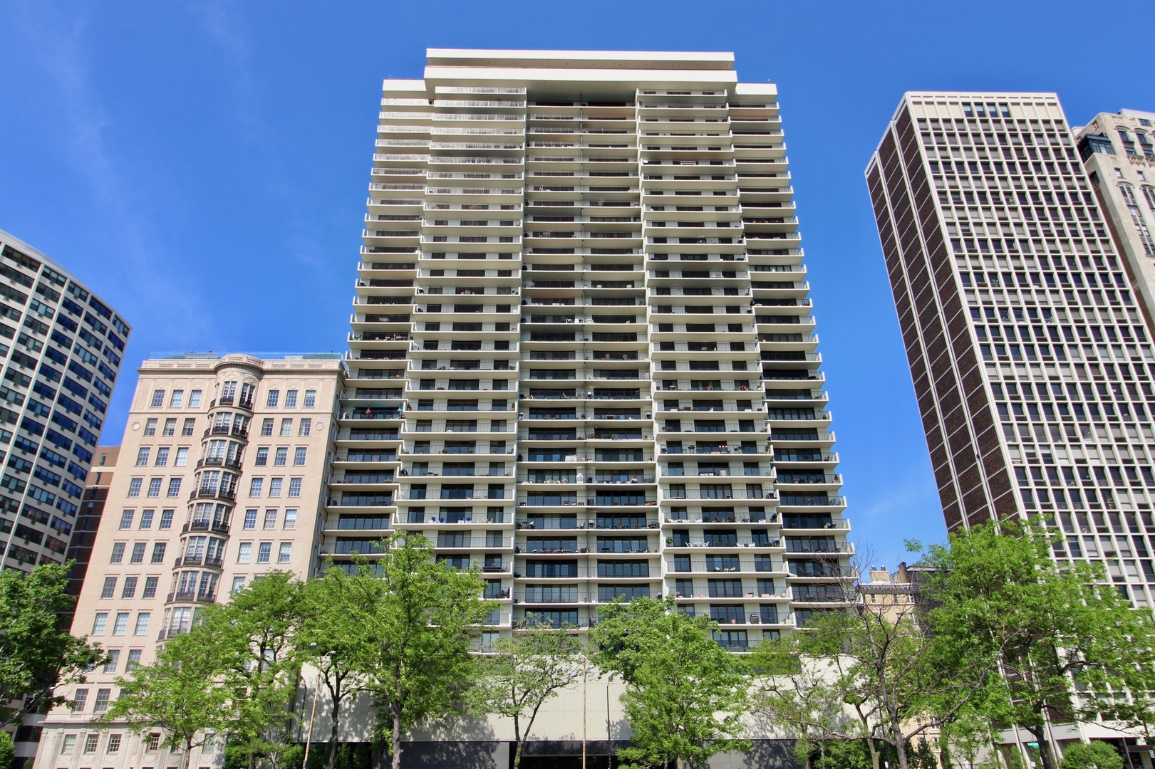 The largest 2 bedroom, 2 bathroom floor plan in one of Lake Shore Drive's most sought after full amenity buildings in the Gold Coast. Enjoy panoramic lake and skyline views from a 27-foot lake facing balcony, with unobstructed vistas of the lake, Air and Water Show, Navy Pier fireworks, Oak Street Beach, and the city skyline. Step through elegant double doors into a gracious Carrara marble foyer, leading into a spacious living room and formal dining room, offering panoramic views perfect for enjoying dining with a backdrop of the beach and lake. The beautifully renovated kitchen features imported Italian natural wood cabinetry with frosted glass insets and intelligent storage solutions, including pull-outs and fold-out corners. Sleek granite countertops and backsplash, under-cabinet lighting, and a built-in breakfast bar elevate the space. Appliances include a top-of-the-line stainless steel package, Sub-Zero refrigerator (2021), Miele cooktop, and a stylish glass-and-metal exhaust fan. A newer washer/dryer (2021) has been relocated to the hallway near the bedrooms for added convenience. The expansive en-suite primary bedroom includes two large closets and a walk-in closet. The spa-like primary bath is adorned with pink and white Italian marble, a wall-to-wall custom marble vanity, designer sink and faucet, and a Jacuzzi tub with hand shower and gold-plated hardware. The second bath showcases an imported Italian wood vanity with a seashell-shaped sink, Italian fixtures, and marble tile work with multiple shower heads and body sprays. Both bedrooms open to west-facing balconies with stunning city skyline view. Enjoy the best of Gold Coast living in a full-service, pet-friendly luxury building featuring 24-hour door staff, on-site management and engineer, a rooftop indoor pool with panoramic lake views, two spacious sun decks, a fully updated party room with indoor/outdoor seating and catering kitchen, fitness center, heated valet garage with guest parking, receiving room, and assigned storage. Smoking is permitted on balconies only. The building is financially strong with $3.5M in reserves and no special assessments. Schedule your private showing today.
