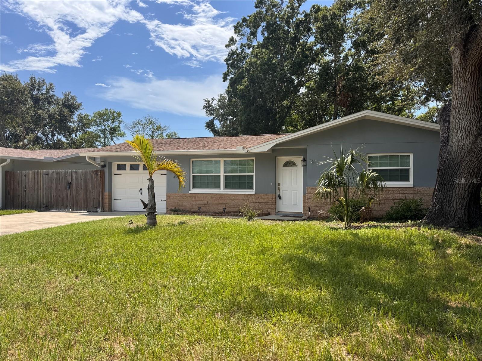 NEW HVAC SYSTEM W/TRANSFERRABLE WARRANTY AUG 2026...Welcome home to this stylishly updated 3-bedroom, 2.5-bath residence perfectly situated in one of Dunedin’s most sought-after neighborhoods just minutes from Downtown Dunedin’s shops, restaurants, the Pinellas Trail, Honeymoon Island and the Gulf beaches.  Featuring modern finishes, an open-concept layout, and a spacious backyard, this home offers the ideal blend of comfort and Florida lifestyle charm.  Step inside to discover a bright and inviting living area accented by laminate flooring and abundant natural light. The updated kitchen boasts granite countertops, stainless steel appliances, white cabinets, and a convenient kitchen island—ideal for cooking and entertaining.  The primary suite includes a walk-in closet and spa-inspired ensuite bath, complete with a double vanity, garden tub and a beautifully tiled shower. Two additional bedrooms provide plenty of space for family, guests, or home office use.  This home boasts a living room, dining, and family room, offering multiple options for usage. Enjoy Florida living at its finest in the fenced backyard, perfect for relaxing or hosting gatherings. There is plenty of storage with 2 outside storage sheds and an additional parking pad for all your toys.  Additional features include impact windows (2015), tankless water heater, and updated electrical. The one car garage houses the washer and dryer, as well as a shower for a quick rinse when returning from the beach. Roof 2014, HVAC 2026. The property is move-in ready and waiting for you to start your next chapter in this exceptional Dunedin home!  Some pictures have been virtually staged to expand your vision.  This home DID NOT flood in the 2024 hurricane season.