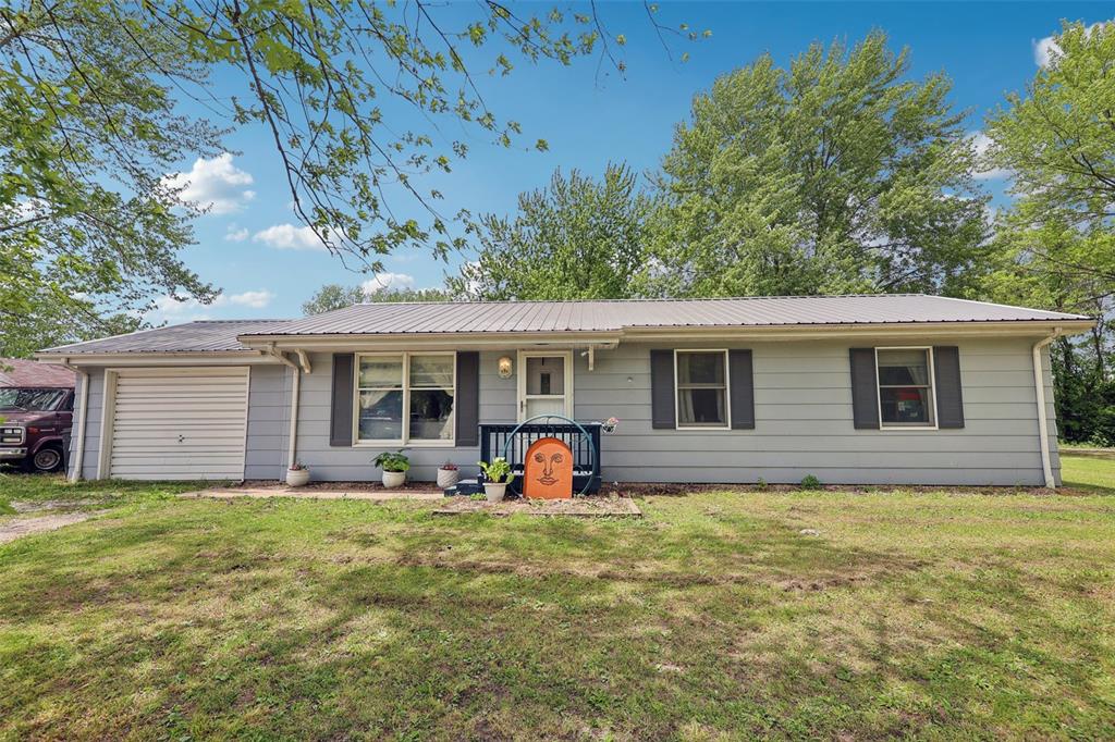 MOVE IN READY one level home! Check out this 3 bedroom, 1 bathroom ranch style home. Beautiful kitchen and dining area with tile backsplash, a pantry, lot of counter space and a sliding door that leads to a screened in porch. Three good sized bedrooms, plus a large living room. Main level laundry, and an attached garage! Metal roof done in 2020, new sump pump and gutters in 2023, plus kitchen updates. Call your favorite agent today and come see for yourself!