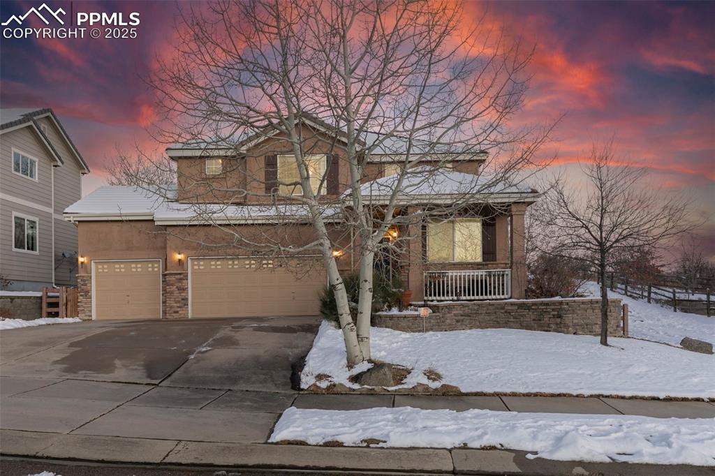 Welcome to this beautiful gem in District 20! This home has so much to offer—starting with stunning Pikes Peak and Air Force Academy views and a private backyard that’s absolutely made for relaxing and entertaining. Walk inside and you’ll find a bright formal living room with vaulted ceilings. An open concept floor plan that floods with natural light, this home is going to capture your heart from the moment you walk inside. The kitchen has a warm, farmhouse feel which opens to a cozy family room complete with gas fireplace. You’ll also appreciate the main-level laundry and powder room and stunning wood floors throughout the main level which give everything a warm, welcoming touch. Head upstairs and you’ll love the spacious primary suite with a walk-in closet and 5-piece bath. An additional 3  generously sized bedrooms along with another full bathroom featuring a doublevanity complete the upstairs. The finished basement adds even more space—two very large rooms with walk-in closets, a roomy entertainmentarea, a stylish bathroom and plenty of storage. The outdoor spaces are just as impressive. The front has a large coveredmporch that’s perfect for summertime and the backyard is your own private oasis. There’s a stamped-concrete patio, a gas fire feature that lights with the push of a button, wiring for a hot tub, and beautiful two-tiered gardens that bloom beautifully in spring and summer. The lot backs to a park—so you’ll enjoy peace, privacy, and great views for years. With a 3-car garage, gorgeous landscaping, tons of space, and an amazing neighborhood, this home truly has something for everyone.