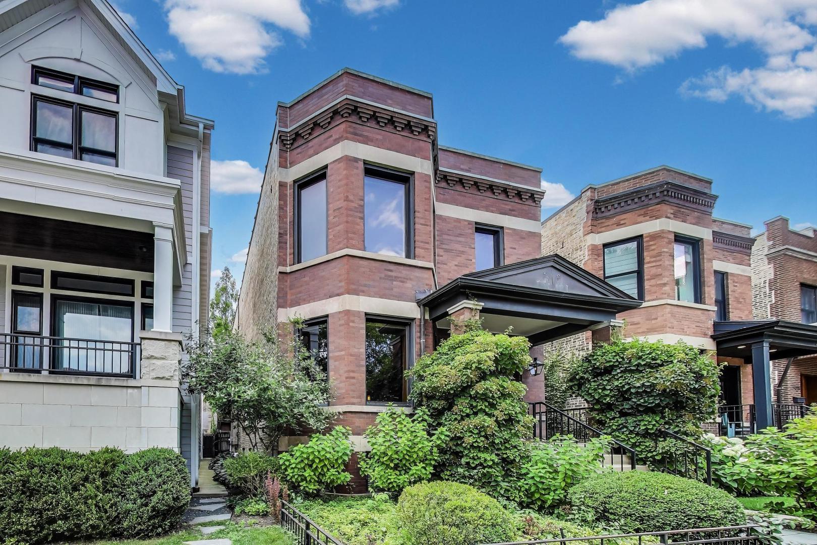 One-of-a-kind transformation of a classic Chicago brick two-flat into a custom-designed single-family residence in the heart of Northcenter. Affectionately known by neighbors as the "Gas-Light House," this distinctive 3-level home blends early 1900s craftsmanship with exceptional modern upgrades.    You are welcomed into the dramatic two-story entry gallery featuring a 20-foot exposed brick wall and hand-crafted steel staircase-a showcase of timeless masonry and custom design. The open-concept main level offers generous living and dining spaces, complete with a bar/office nook and space to display your prized collectibles or vintage motorcycles.    The chef's kitchen is truly exceptional: a 10-burner Lynx Star Pro range with double oven, stainless Viking commercial-grade double hood, Sub-Zero refrigerator and separate freezer, granite-topped center island, custom buffet, and butler's pantry. A hidden powder room with Art Deco flair completes the main level.    Upstairs, the front bedroom is bathed in natural light and served by a full vintage Kohler bath featuring a clawfoot soaking tub. The rear of the upper level is dedicated to the luxurious primary suite, with sound-absorbing upholstered walls, built-in surround sound, and a spa-inspired bath with Jacuzzi tub and glass-enclosed shower-featured on HGTV's "Love That Bath". The custom walk-in closet offers extensive storage with accent lighting and built-ins.    The lower level includes a private home gym, guest bedroom, full bath, and a bright, well-appointed laundry room with high-end appliances, cabinetry, utility sink, and hanging space.    At the rear of the home, the stunning family room addition pays homage to Prairie and Arts & Crafts architecture-with rich wood-paneled walls, beamed ceilings, gas fireplace, stained glass windows, and period-perfect lighting. Glass doors open to a beautifully landscaped patio beneath a soaring pergola, ideal for outdoor entertaining.    The heated 2019-built garage is more than just a parking space: it includes a lofted storage level, workshop power supply, fire-resistant Hardy board siding with wood shake accents, and reclaimed original windows and doors. Outdoors, enjoy a built-in grilling station with a stainless Lynx rotisserie infrared grill, storage, and a peaceful koi pond.    Mechanically superb, the home features dual-zone HVAC, new windows, a rubber roof, gutter heaters, upgraded drainage, and a comprehensive flood protection system-all sure to impress your inspector.    Located on one of Northcenter's most coveted blocks, just steps to award-winning Bell School, Lane Tech, parks, restaurants, shops, theaters, public transit, Wrigley Field, Lake Michigan, and the North Branch Riverwalk. This home would be extraordinary anywhere-but here, it's exceptional.    Come experience it for yourself.