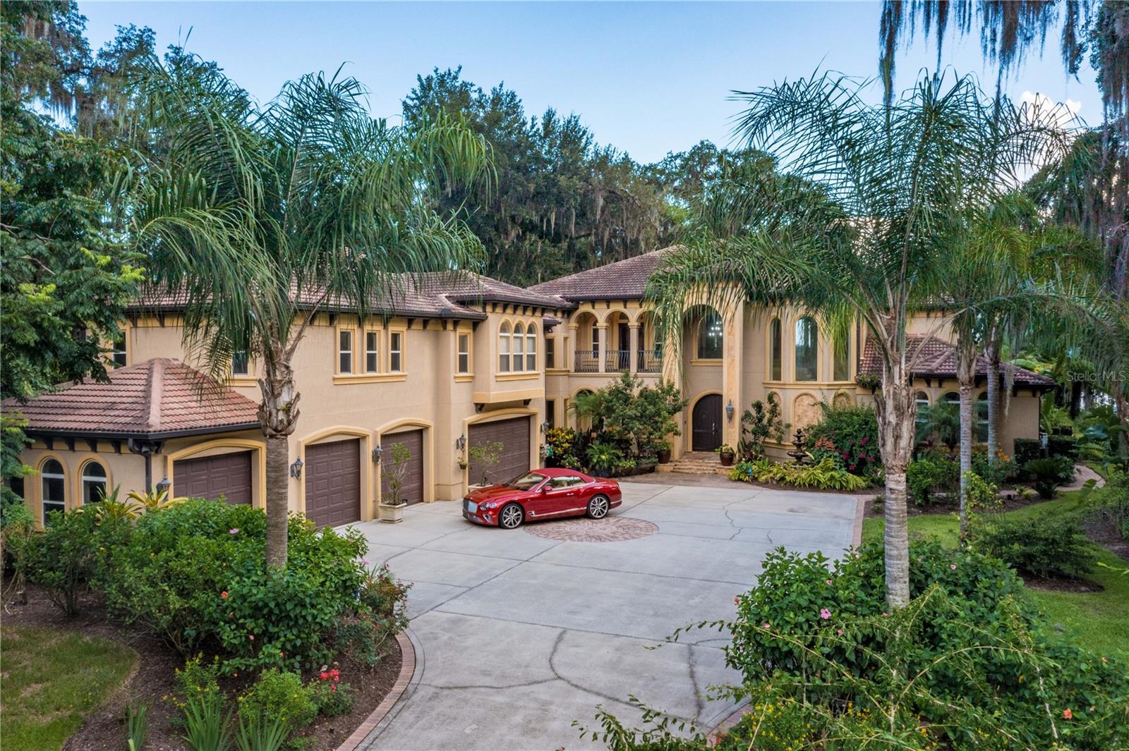 Mediterranean Luxury Riverfront Estate, a private gated St Johns River Estate built on 1.43 acres is a slice of paradise offering resort style amenities designed for entertaining. Custom built to perfection spanning over 6268 sqft 5-bedroom, 8 bath estate expresses the ultimate in Florida outdoor luxury living experience. The main house layout starts with a 2 story grand entry and a sweeping custom designed iron staircase, second story interior balcony, wine cellar, gourmet chefs kitchen, large billiard & theater room and 1st floor owners retreat overlooking resort pool with river views. In addition to the main house, you will find a separate caretakers quarters/guest cottage with 3bedrooms/2baths for privacy. This stunning estate includes 7 car garage & 25x50 AC and heated work garage.Enter through the 6x8 solid French wood door into a stunning 6,268 Sqft Mediterranean home. You are greeted by the great room that features a gas & wood fireplace with custom bookcases and stunning 22ft 2 steps knock down custom coffered wood ceilings. The exquisite gourmet chef's kitchen features stainless steel appliances, a Samsung double door refrigerator, a large breakfast bar with custom cabinets and a large walk-in pantry. The open dining room features great views, with a built-in butler's pantry/bar with cabinet lighting. Open the French doors which lead you to a 57' Veranda overlooking the pool and riverfront. The private owners retreat boasts 10' ceilings with hand painted murals, a large gas fireplace, California Berber carpeting, custom silk window treatments and beautiful French doors leading out to lanai. The owners bath greats you with imported Italian Stones, Italian granite, and custom workmanship. Relax in the steam dual rain shower. Take the wrought iron spiral staircase which leads you to the atrium with wood floors & 10' dome. As you enter the carpeted theatre room you are welcomed with 7 surround sound speakers with dark ceilings and black out drapes, perfect for a movie night. The billiard room showcases hardwood floors, with a gas fireplace, custom bookcases, and a wet bar that features granite countertops with built in cabinets.This Spectacular Waterfront Estate Lot features 107ft Bulkhead WF with St. Johns River views. Enjoy a tin roof boat house with a deep-water dock. The salt water heated pool features water purification/self-cleaning filtration. The pool is surrounded with Italian Stone, custom walk-in waterfall, spa, swim up bar, and a 4' beach island. This home has a tropical landscape with outdoor lighting, gated grand entryway, a wrought iron fence, and a sprinkler system. Relax at the summer kitchen or by the outdoor fireplace. An outside cabana bath features storage and an outdoor lounge area. Enjoy your 3BR|2B 1250Sqft guest cottage, with a living room, kitchen, and private parking. Find your oasis at this private protected cove home.