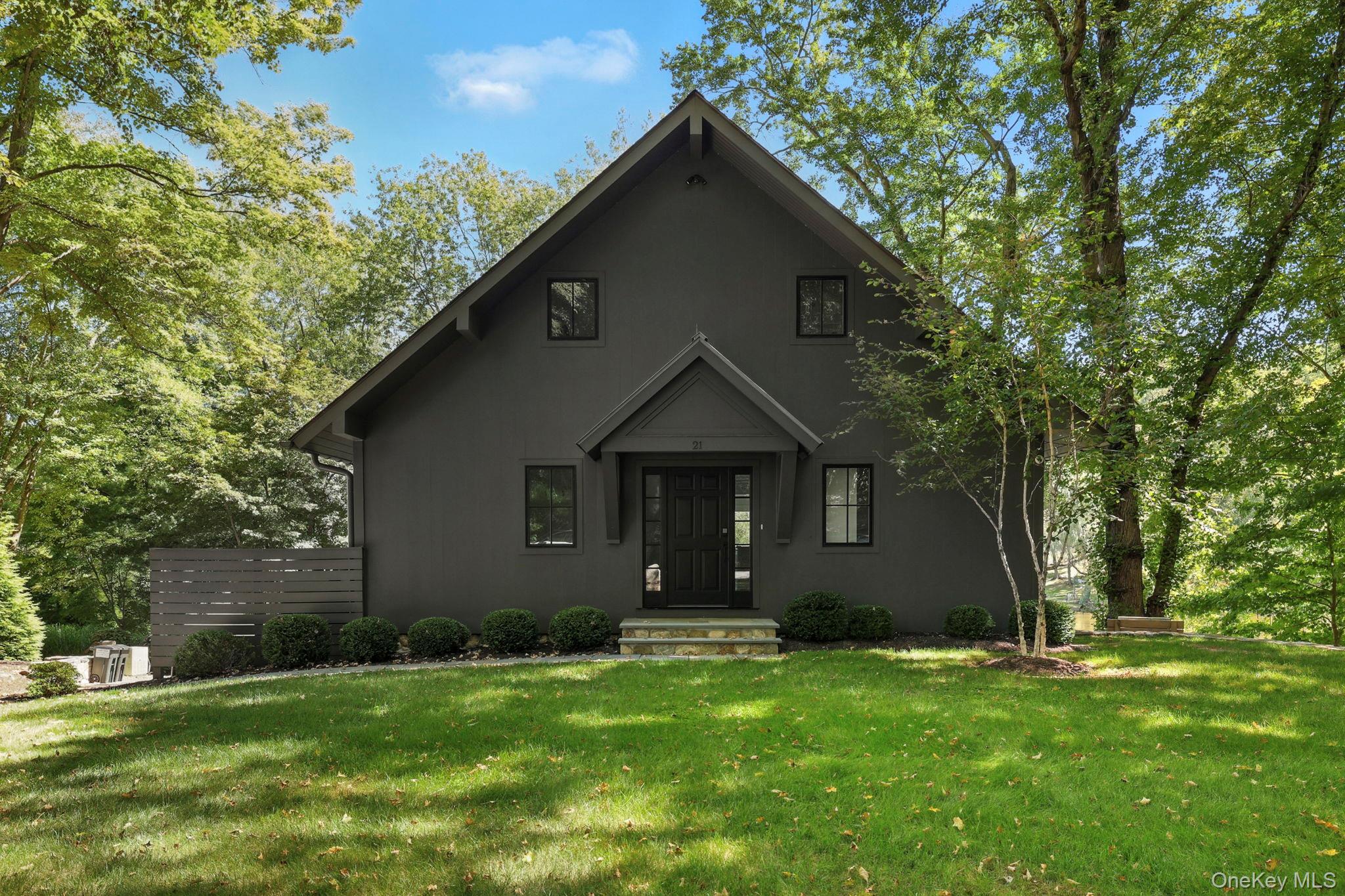 On the serene shores of Lake Truesdale in South Salem sits Blackbird Cottage, an utterly charming two-bedroom that truly lives like a three. Built in 2020, the home still feels brand new inside. Step into a light-filled entry and continue into a spacious open living area. The stylish kitchen features a center island and chef’s appliances, while the adjacent dining area is a magical retreat surrounded by windows, making you feel as though you’re floating above the lake, almost like a treehouse in the sky. Upstairs, you’ll find two generous bedroom suites, both with lake views, and a chic, spa-like bathroom. The lower level offers incredible flexibility with a large bonus room and full bath, perfect for use as a lounge, mudroom, office, or guest space. Outdoor living is just as special as the entertainment on the perfectly scaled Trex deck overlooking lush green surroundings, or gathering around the fire pit in Adirondack chairs with friends and a glass of lemonade. A lower level covered patio invites you to sit back and enjoy the sound of the rain on a lazy rainy day, while a newly constructed private dock extends the living space onto the water where you can paddle board, canoe, or row across the peaceful lake. This truly is a four-season lake house — as special in spring, summer, and fall as it is in winter, when you can ice skate on the frozen lake or even play a game of hockey. Come sit on the porch, catch the breeze, listen to the birds and the sounds of nature as you gaze out over the water