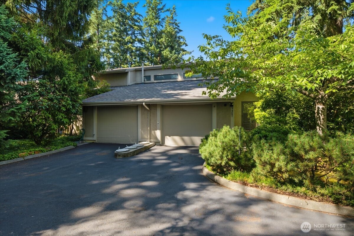 Welcome to your private Edmonds sanctuary! This corner-unit townhome offers a peaceful, light-filled setting with thoughtful upgrades throughout. The spacious sunken living room showcases a raised-hearth fireplace, a dramatic wall of windows, and seamless indoor-outdoor flow to the fenced concrete patio via upgraded French doors. A large bay window and the removal of a wall create an airy, open-concept design ideal for everyday living and entertaining. The kitchen features ceramic tile flooring & gas range w/air fryer. Additional upgrades include laminate flooring, glass fireplace doors, a modern staircase handrail, & separate bedroom heating systems for customized comfort. A main-floor powder room for guests. Upstairs, clerestory windows brighten the main bath, while the full-size stackable washer and dryer are ideally located near the bedrooms. The tranquil primary suite is a true retreat with a fireplace, walk-in closet w/organizer, and a spa-inspired ensuite featuring a skylight, double vanity, walk-in shower with grab bars, & built-in seating. Additional highlights include a central vacuum system, a spacious storage loft above the large attached garage, & lovely landscaped wooded grounds within this rare 13-unit security gated community. Room for more updating & painting & priced accordingly. Minutes from downtown Edmonds, Waterfront & Senior Center, beaches, parks, ferry, shopping & dining. Minutes to light rail, Alderwood Mall, & freeway access. Be quick!