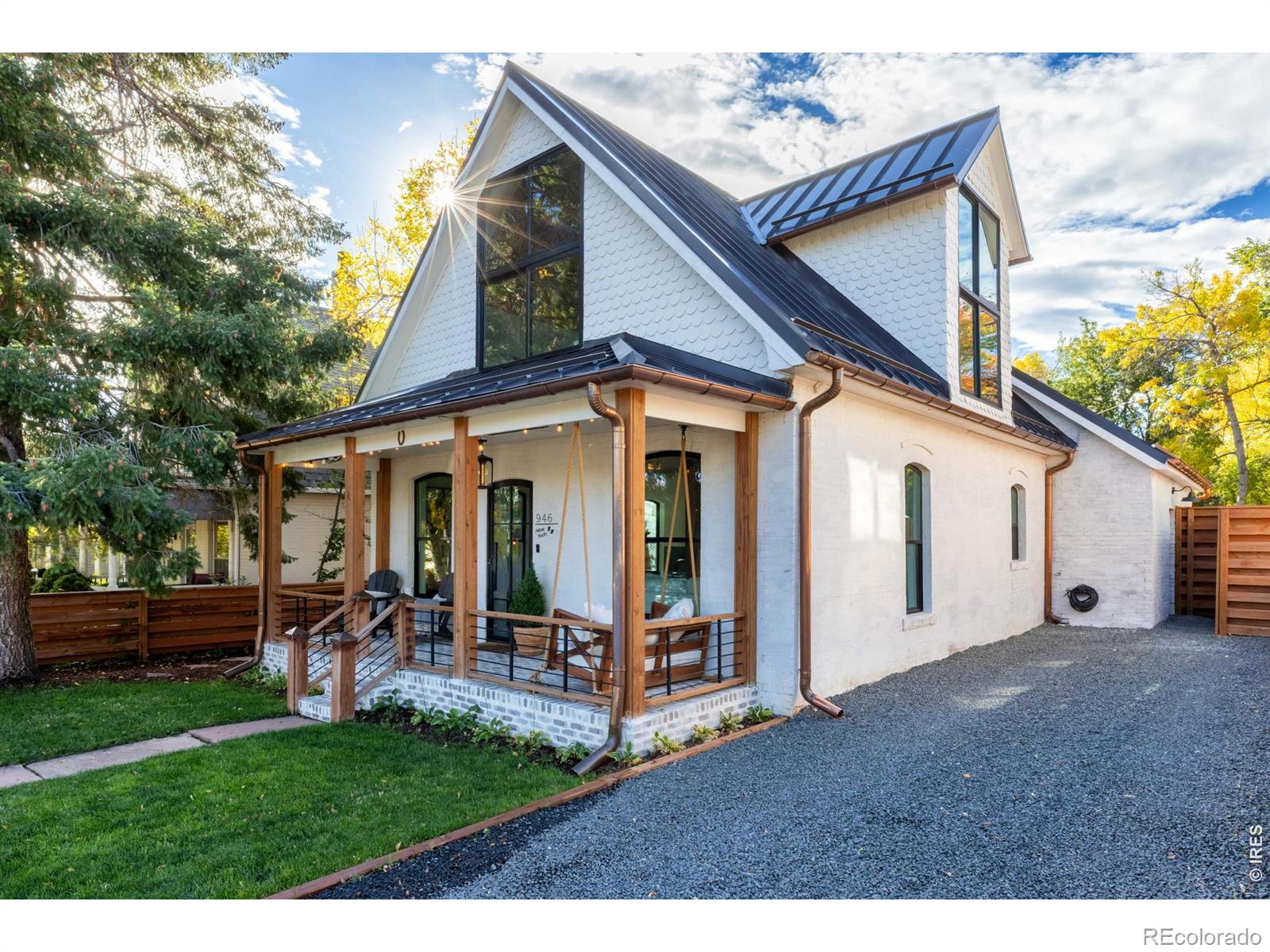 Rare Opportunity to live in this completely reimagined North Boulder home where EVERYTHING is BRAND NEW, from electrical and PEX-A plumbing to the reinforced foundation. Thoughtfully REBUILT with quality in mind, this sun-filled home has been EXPANDED to maximize space and offers modern living, including a dedicated work-from-home space on the main level. Step inside to find high ceilings, cedar paneling, new 7-inch white oak floors, and enlarged new windows and doors that frame stunning foothills views to the west. Open-concept living space features a non-emitting fireplace and flows seamlessly into a beautifully designed kitchen with new cabinetry, a waterfall quartzite island, farm sink, built-in refrigerator and dishwasher, beverage center, walk-in pantry, and retractable connectivity to the outdoors through new French doors. Enjoy true indoor-outdoor living as the kitchen opens to an electric heated POOL and an incredible backyard with MATURE TREES, a new fence, all situated on a rare double lot with buried power lines. The home includes all new HVAC with new heat pumps, brand new ductwork for both cooling, a 200-amp electrical panel with new wiring, and is fully electric for ECO-FRIENDLY living. Additional upgrades: new insulation including spray foam, brick tuck-pointing, a 16-gauge bronze steel roof and 6-inch Half Moon Copper Gutters, an EV charger, and all new lighting and electrical throughout. The mudroom is complete with lockers, a dog washing station, and stackable washer and dryer. The upstairs features two bedrooms with retractable blinds and motion-sensor lighting in the walk-in closets. The upstairs bath offers a double vanity and rain shower head with high-end tile finishes. The main-level bath includes a soaking tub for relaxation. Located WALKING DISTANCE from the Sanitas trail system, PEARL STREET, & North Boulder Park. This move-in-ready home combines modern efficiency, thoughtful design, and unbeatable walkability in the heart of Boulder.