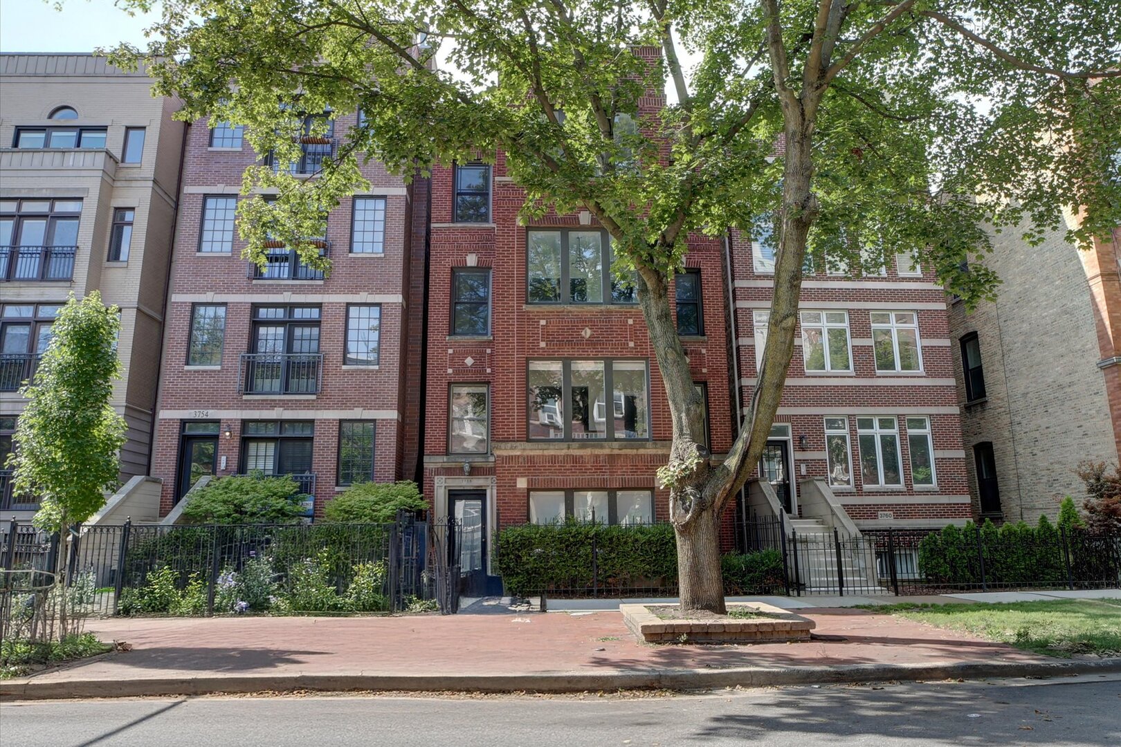 Smart living meets timeless value at 3758 N. Fremont St. #2, a beautifully designed 1,400 sq. ft. residence located on the third floor of a boutique 3-unit brown brick building in the heart of Wrigleyville. This freshly painted 2-bedroom, 2-bathroom + den home combines modern convenience, flexible design, and a location that captures everything buyers love about Chicago's North Side.  The thoughtfully crafted floor plan features a light-filled east-facing den with seven oversized windows that bring in sunrise light and treetop views, creating the perfect space for a home office, reading nook, or creative retreat. The inviting living room with fireplace offers a cozy yet stylish backdrop for both quiet nights and entertaining. At the center of the home, the large eat-in kitchen showcases stainless steel appliances, abundant cabinetry, and French doors opening to a spacious west-facing deck-ideal for grilling, entertaining, or enjoying golden Chicago sunsets. Two generously sized bedrooms and two full bathrooms round out the home's functionality, ensuring both comfort and privacy.  This residence delivers rare value with two included outdoor parking spaces, a highly desirable amenity in Wrigleyville that enhances everyday convenience and strengthens future resale potential.  Step outside and you're moments from everything that defines this iconic neighborhood: Wrigley Field, the Lakefront Trail, and Montrose Beach. Enjoy world-class entertainment at neighborhood favorites like Murphy's Bleachers, The Cubby Bear, and Sluggers, or savor local dining gems like Uncommon Ground and Small Cheval. With excellent CTA access, vibrant nightlife, annual festivals like Northalsted Market Days and Pride Fest, and cultural events year-round, this home offers a lifestyle that's as exciting as it is practical.  3758 N. Fremont St. #2 is more than a home-it's a rare opportunity to invest in comfort, convenience, and the vibrant lifestyle that makes Lakeview and Wrigleyville among the most sought-after neighborhoods in Chicago.