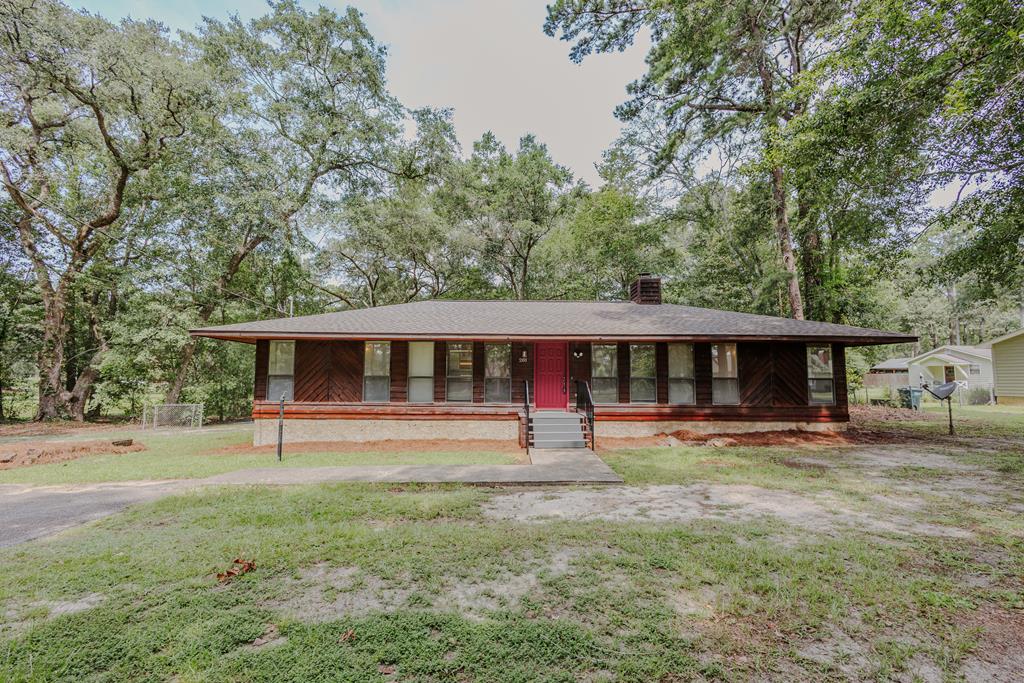 Check out this uniquely styled contemporary home in Thomas County! 4 bed & 3 bath with 1.48 acres on a quiet street just minutes from the conveniences of Thomasville. Spacious floor plan of 1,945 sf has open living/dining room anchored by a wood burning stove fireplace and beautiful accent beams in the ceiling. TWO master suites both have walk-in closets plus a Jack and Jill Bathroom between 2 additional bedrooms. Cozy kitchen is partially open to the living areas and has a NEW skylight for keeping your days bright without burning the lights all day. There is a large separate laundry room with room for storage and has a utility sink. Easy access to the large deck which over looks the fenced backyard. Recent improvements include new vinyl plank flooring, new interior paint, one of two water heaters replaced (other has been recently replaced), new roof in October 2024, new exterior staining of siding, new front porch decking and handrail, and new moisture barrier in crawl space. Call today to schedule your appointment.