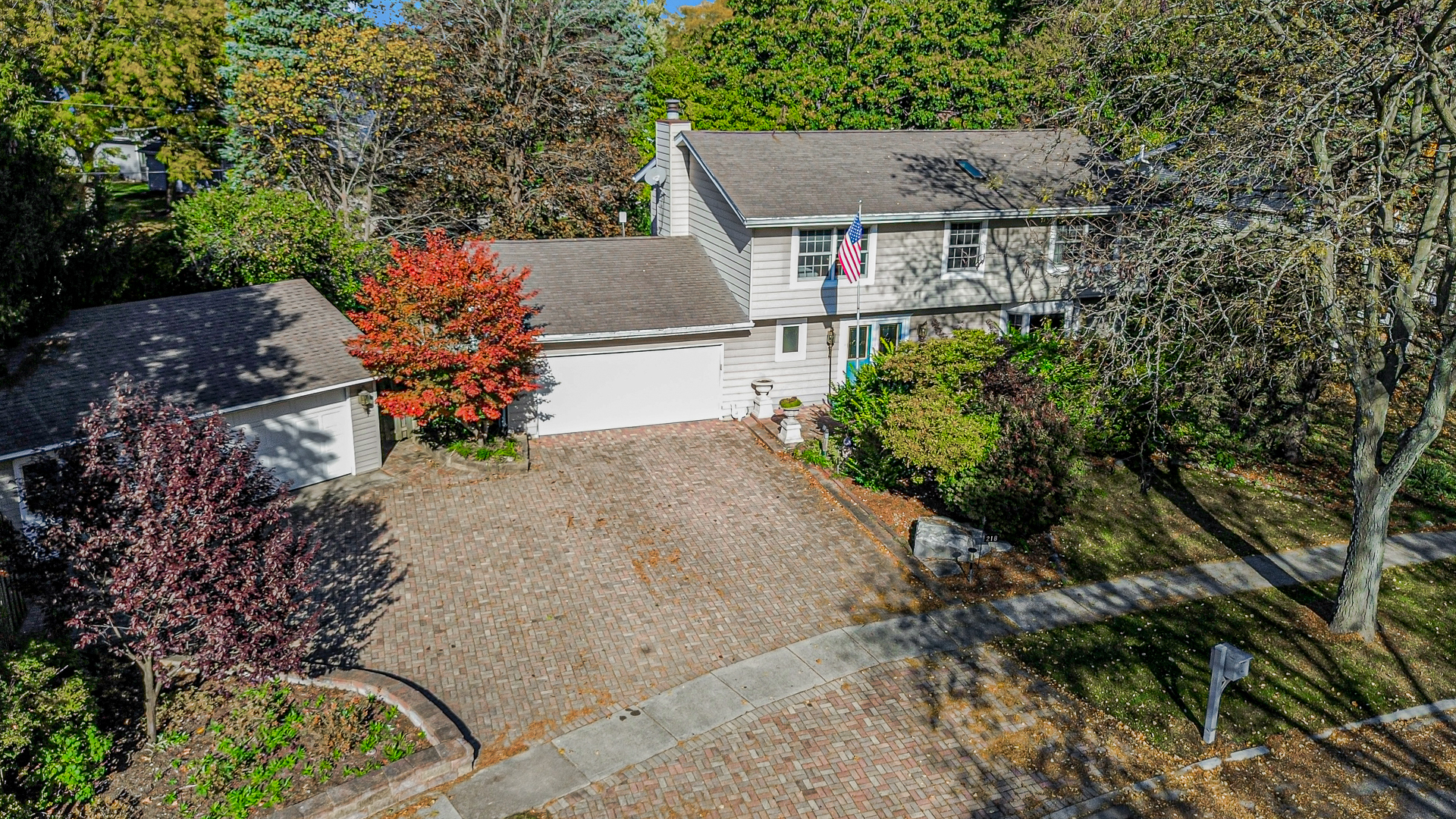 Enjoy the best of Loch Lomond Lake living in this one-of-a-kind, spacious 4-bedroom, 4-bath home offering an abundance of space, versatility, and exceptional amenities! Designed for comfortable everyday living and effortless entertaining, this home features an inviting open floor plan, a welcoming formal entry with double closet, and an oversized living room highlighted by a large bay window.  The heart of the home is the impressive chef's kitchen, featuring stainless steel appliances, a 48-inch range with built-in griddle, expansive center island, granite countertops, abundant cabinetry, and skylights that fill the space with natural light. Convenient access to the brick paver patio makes indoor and outdoor entertaining a breeze. The elegant dining room offers a beautiful brick fireplace and built-in cabinetry, adding warmth and character. A first-floor full bathroom, generous storage, and laundry facilities on both the main level and in the basement provide added convenience. The spacious primary suite is a relaxing retreat with double closets and a private bath featuring double vanities, an oversized whirlpool tub, and separate shower. An additional bedroom offers its own full bath, while two more bedrooms share a hallway bathroom. A second-floor wet bar adds another special touch for entertaining. The full basement, complete with exterior access, provides abundant storage and endless possibilities for additional living space, recreation, or hobbies. A roughed-in bathroom offers even more potential for future expansion. Set on an expansive .43-acre lot, the property features a fully fenced backyard and multiple brick paver patios, creating wonderful spaces for outdoor dining, entertaining, or simply relaxing. A beautiful stone paver driveway enhances the curb appeal, while the rare combination of a 2-car attached garage and a separate 2-car detached garage offers parking for four vehicles and exceptional flexibility for car enthusiasts, hobbyists, or additional storage needs. Best of all, the lake and beach are just across the street, offering convenient lake access and the opportunity to enjoy all that Loch Lomond living has to offer! With its spacious floor plan, impressive chef's kitchen, generous outdoor spaces, four-car garage capacity, and desirable location near the lake and beach, this home offers a unique opportunity to enjoy space, comfort, and a wonderful lake lifestyle. Property is being sold AS IS.