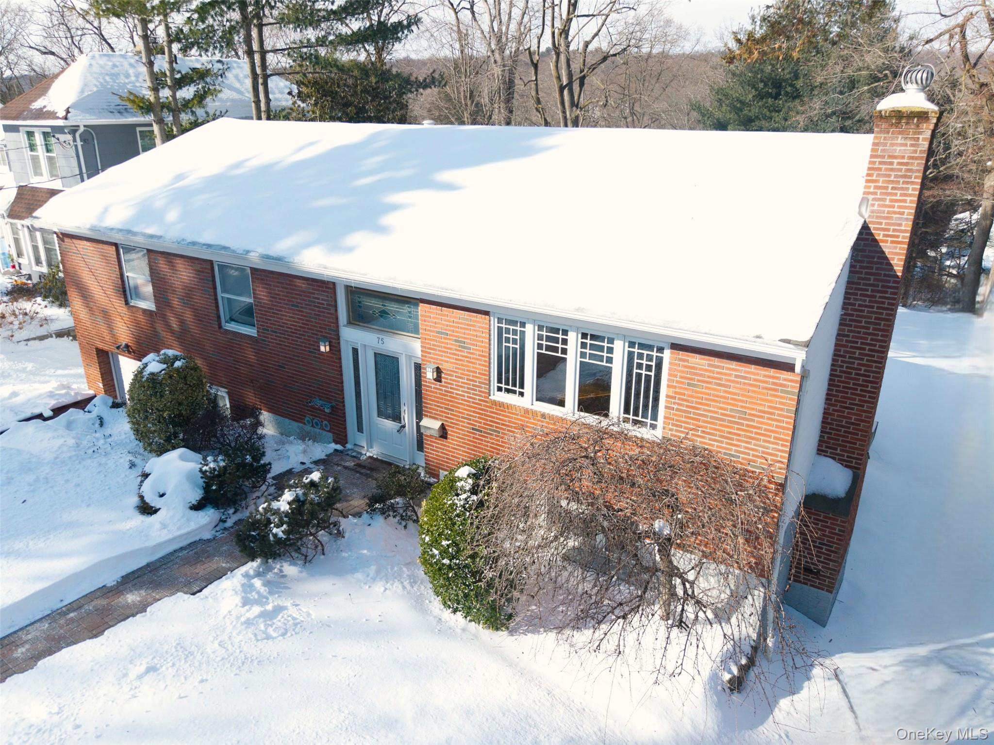 Located in highly desirable Manor Woods, only a short stroll to Hartsdale Village and the Train Station, this expansive brick home is ready to move right in!  Boasting extra large rooms, 5 Bedrooms and 3 Full Baths, a Chef's Kitchen at the heart of the home, a walk out lower level with a Family Room/Fireplace, Office/Gym and room for everyone!  Meticulously maintained and updated, 75 Holland Place has everything you could want and need including newer HVAC and roof, modern Kitchen and Baths and a stunning new Trex deck. Solar Panels - seller will pay off the lease so that you can enjoy all the benefits of a state of the art system, $30 per month electric bill, free maintenance and can be transferred to any subsequent owners, all with no lease cost!    Greenburgh amenities. https://www.greenburghny.com/162/Programs-Activities