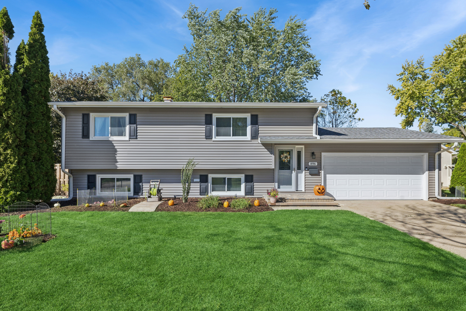 Welcome to 896 Canterbury Drive - where comfort meets convenience in the heart of Crystal Lake!    This beautifully cared-for split-level home is perfectly situated right across from Canterbury Park, the bike trail, and Canterbury Elementary School, offering an unbeatable lifestyle surrounded by green space, recreation, and community charm.    Inside, you'll find a unique and inviting layout with the kitchen located on the lower level - ideal for entertaining and everyday living. Originally a four-bedroom home, one of the rooms has been thoughtfully converted into a formal dining area, adding flexibility to suit your needs.    Enjoy two updated full bathrooms, a bright sunroom overlooking the fenced backyard, and plenty of natural light throughout the home.    Recent updates provide peace of mind, including:    New roof, gutters, and downspouts    Newer windows and appliances    Epoxy-finished garage floor      Lovingly maintained by the same owner for the past 25 years, this home radiates pride of ownership and care in every detail.    Come see for yourself why this Crystal Lake gem stands out - a great home, in a great neighborhood, at the perfect location!