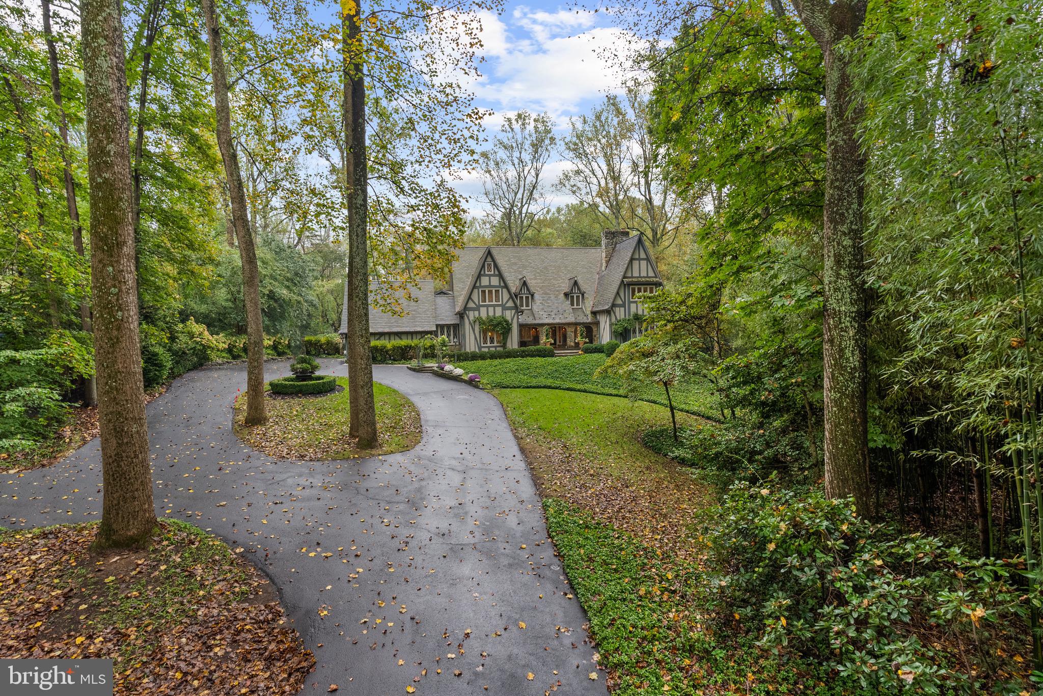 10205 Cedar Pond Drive is where the Fairy Tale Begins.  With over 7400 Sq. Ft. of Living Space this  HIDDEN OASIS IN ONE OF THE MOST SOUGHT-AFTER AREAS OF VIENNA.  Magnificently sited on 1.23 acres backing to 15 acres of woods, this exceptional estate offers unmatched privacy and character while remaining just minutes from McLean, Tysons, and Reston Town Center.The approach begins with a gentle hilltop location and meticulously landscaped grounds framed by mature trees, setting the stage for the romantic architecture and elegant interiors. At the heart of the home, a stunning custom kitchen by Apex Homes features custom Neff cabinetry, professional-grade Wolf and Sub-Zero appliances, and an expansive design ideal for both everyday living and entertaining. The adjoining formal dining room is highlighted by a dramatic plaster groin-vaulted ceiling and walls of windows that capture serene views of the landscaped grounds and pool beyond. A sun-filled garden room opens directly to the rear terrace, blending indoor and outdoor living. The spacious main-level family room adjoins a paneled study providing the option of a first-floor primary suite.The rear garden is a resort-like destination, featuring stone terraces, formal gardens, fountains, and mature trees—all anchored by a resort-style swimming pool, spa, fire pit, and two custom gazebos.Upstairs, the primary suite offers a fireplace, an extraordinary custom dressing room with handcrafted burled walnut and mahogany cabinetry, and a spa-inspired bath designed for relaxation—two additional bedrooms on this level feature cathedral ceilings and abundant windows overlooking the gardens.  The lower level provides remarkable flexibility for guest accommodations, fitness, media, or lounge space.Every room reflects a commitment to quality and craftsmanship, with timeless design, abundant natural light, and a seamless blend of European character and luxury. This is more than a home—it’s a lifestyle.
