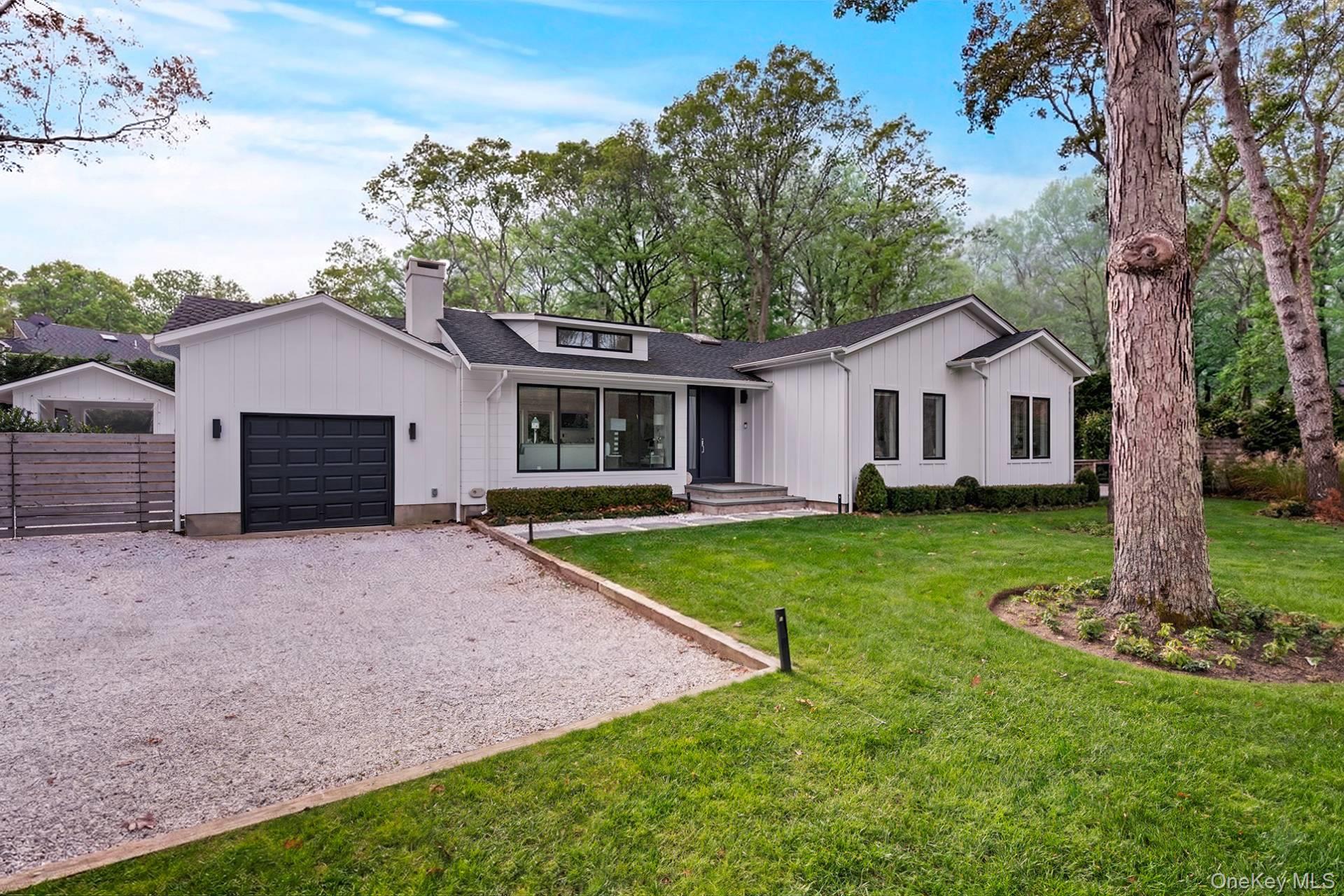 Recently reimagined from top to bottom, this striking single-story residence with expansive finished lower level delivers a rare blend of high-design finishes, functional living space, and a true backyard retreat-all in the heart of East Hampton. Offering 4 bedrooms, 4 full bathrooms, and 2 half baths across a thoughtfully designed layout, the home pairs effortless main-level living, a resort-like outdoor lifestyle along with exceptional amenities in the lower-level allowing big groups to find multiple quiet places to spread out and relax or work, inside or out. The main floor is anchored by a beautifully executed open-concept living space, seamlessly integrating a living room with fireplace, dining area, and a top-of-the-line kitchen-perfect for both everyday living and entertaining. Throughout, the home showcases a refined contemporary aesthetic: porcelain flooring, sleek white kitchen cabinetry, fluted wood accents, and extensive custom millwork and built-ins. The result is a polished, design-forward environment that offers a bit more "edge" than traditional Hamptons design-yet remains warm, elegant, and highly livable. The main level features three bedrooms, including a spectacular primary en-suite that feels more like a private retreat-generously scaled and complete with a separate lounging area and direct access to the rear grounds. The lower level is a standout in both scale and versatility. Designed for modern lifestyles, it includes a spacious great room, full bathroom, private office, wine storage cellar, and a dedicated gym area. A fourth en-suite bedroom-or flexible studio space-features its own exterior entrance, along with a wet bar, refrigerator, its own full bath, making it ideal for guests, extended stays, or even a professional workspace. Outdoors, the property transforms into a true club-like setting. The beautifully landscaped backyard centers around a gunite pool with integrated spa, surrounded by a stone lounging deck and anchored by a covered cabana. The cabana itself offers an additional lower level with a half bath and ample storage-perfect for seamless entertaining. Additional highlights include an attached one-car garage and a comprehensive, high-end renovation that ensures move-in-ready ease with uncompromising quality throughout. A rare offering that combines bold contemporary style with exceptional amenities-designed for both relaxed living and elevated entertaining in East Hampton.