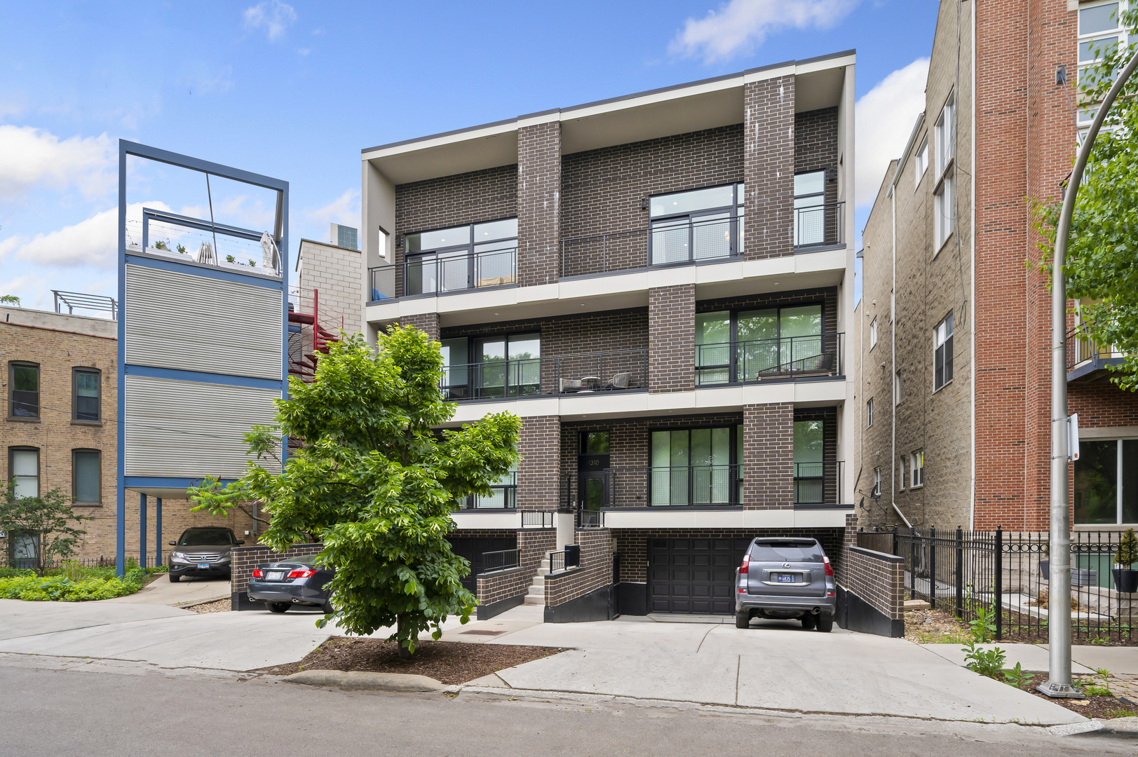 Modern sophistication meets urban living in this extra-wide, full-floor penthouse in Old Town. Featuring 3 outdoor spaces, including an expansive private rooftop deck, this 3-bedroom, 2-bath home is the definition of elevated city living.    An open-concept great room spans the full width of the building, framed by floor-to-ceiling east-facing windows that fill the space with light and lead to a 45-foot front terrace overlooking treetops and peeks of the Chicago skyline. The designer kitchen features white cabinetry, SS appliances, quartz counters with full-height tile backsplash, and a large island with seating for four-perfect for cooking or entertaining.  A large back deck off the kitchen is perfect for grilling.    The primary suite is a serene retreat floor-to-ceiling glass doors that open to a private balcony. The spa like bath features marble tile, an oversized walk-in steam shower, and floating double vanity. Two additional bedrooms offer flexibility for guests or a home office.    A private rooftop deck crowns the home, offering panoramic views of the city skyline, multiple seating and dining areas, and lush turf sections for lounging or play-your own urban oasis above Old Town.    Additional features include oak floors,  attached garage parking plus a tandem exterior space & heated driveway, and a modern brick and glass facade with striking architectural lines. Located steps from Wells Street, North Avenue Beach, Lincoln Park, and the CTA, this penthouse combines tranquility and access in one of Chicago's most desirable neighborhoods.