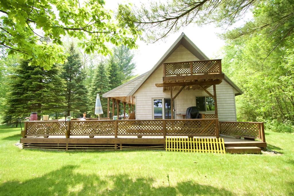 welcome to the Cedar Lake property...northern living at its finest This wooded 1.4 acres opens up to serene waterfront retreat with 140' of all sports Cedar Lake shoreline.  This meticulously maintained property has been completely remodeled with attention to detail starting with vinyl  shake siding, low energy windows, hardwood and Italian tile throughout the living area. This three bedroom two bath residence features an upstairs lakefront owners retreat with sliding door opening up to a 12 x 10 upper deck. Additional features include city water, semi-open floor plan, wraparound deck, 16 x 20 dock, 24 x 36 garage with a work shop and wood burning stove. The owner is currently using the entire 2nd floor as a suit.  Call today for a private showing.