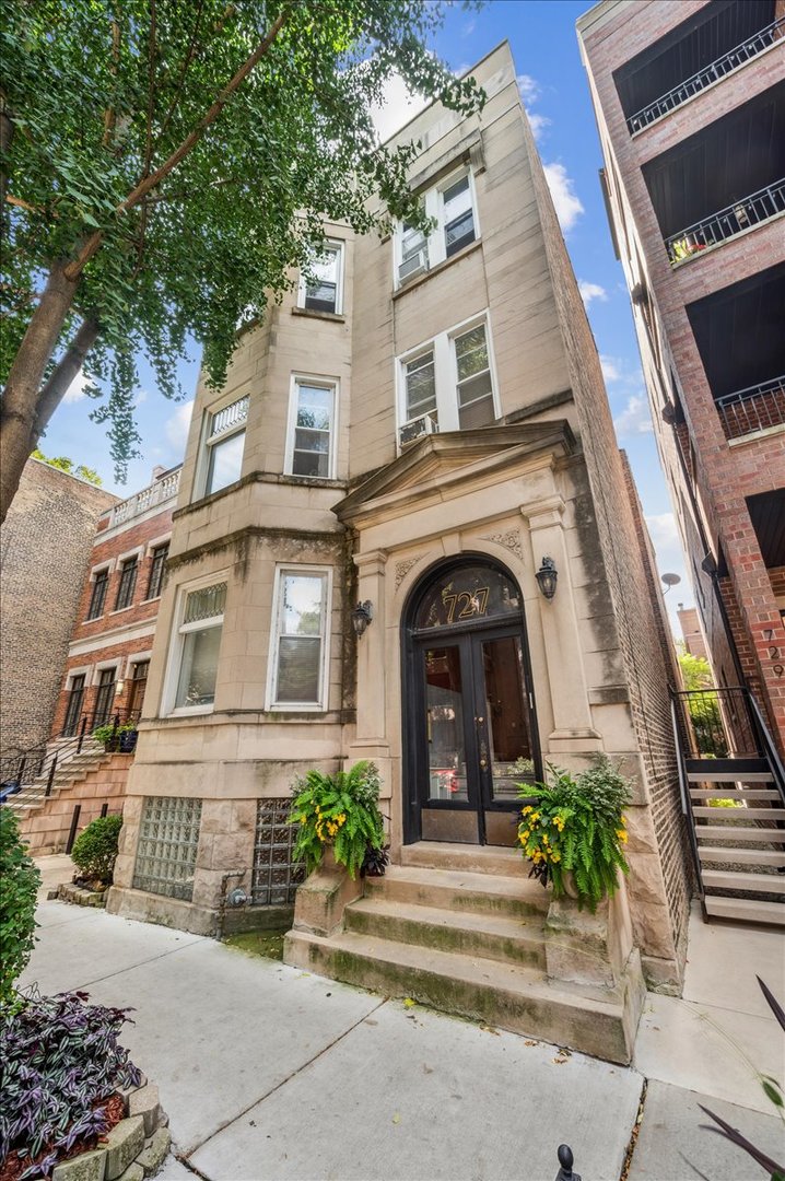 Located in the heart of East Lakeview, perfectly between Broadway and Halsted and just steps from Nettelhorst School, this 3BR/2BA condo combines vintage charm with modern comforts. Set on a high first floor above street level, the home offers both privacy and easy access. A welcoming entry foyer leads into a bright and spacious living room with tall ceilings, hardwood floors, and abundant natural light, while the dining room flows seamlessly into the updated kitchen with crisp white cabinetry-creating an ideal setting for both everyday living and entertaining. Vintage details, including a leaded glass window, an ornate fireplace with tile surround, and classic moldings, add timeless character throughout. The primary suite offers privacy with its own en-suite bath, while two additional bedrooms and a second full bath provide flexible, well-appointed space to suit your family, guests, or home office needs. Additional conveniences include in-unit laundry with extra shared laundry in the basement, a private rear deck, an exterior parking space, and dedicated storage. Set on a beautiful tree-lined street, this home boasts a fabulous location-step out the front door to coffee shops, restaurants, and shopping, with easy access to the Belmont CTA station, Lake Shore Drive, the lakefront, and grocery stores.