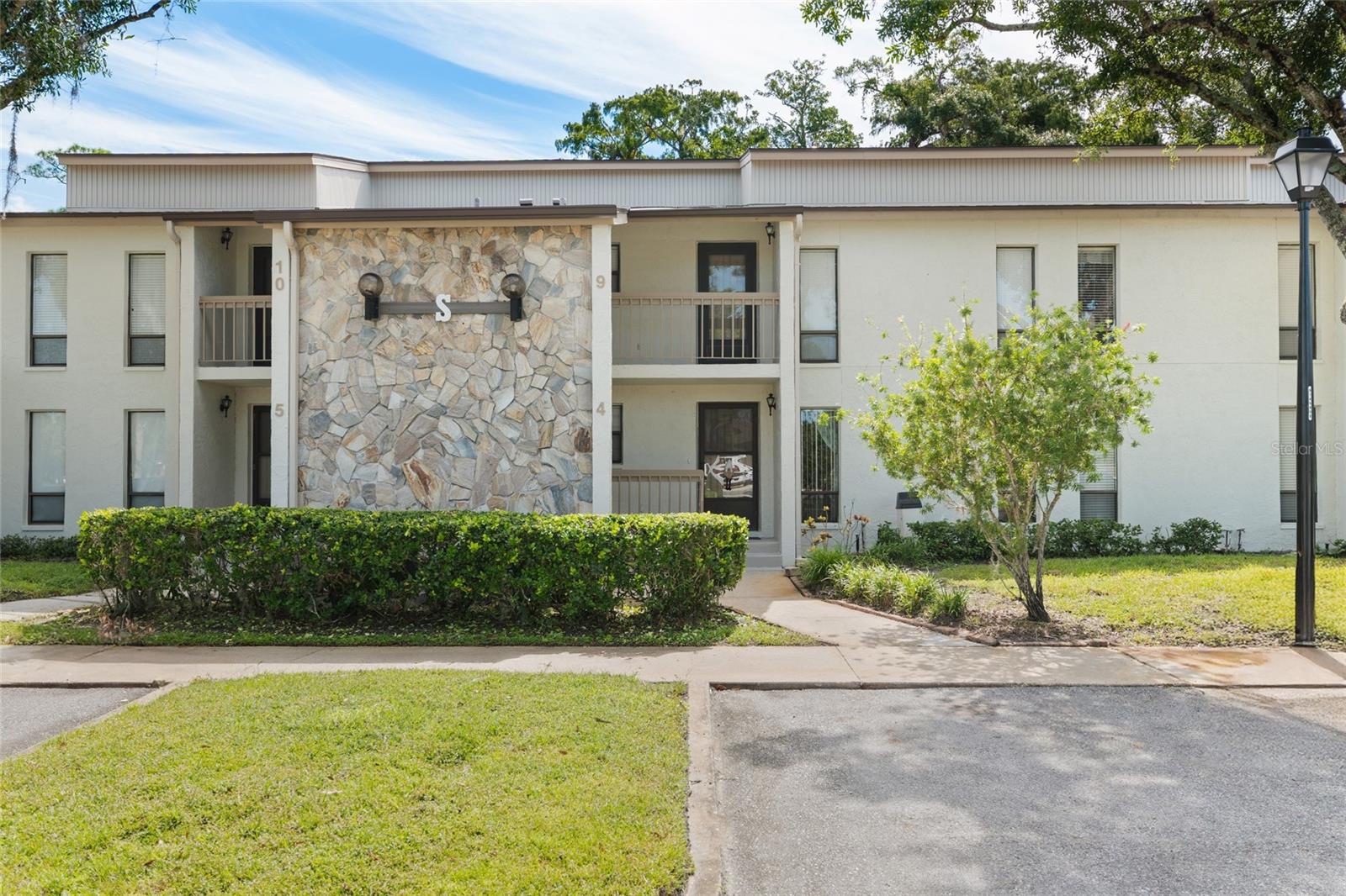 "Newsflash"!!!!! Be the first to come and steal this adorable recently remodeled to the nines.  This 2-bedroom 2 bath first floor condo located in the desirable Tarpon Woods Sub-division. This home has a front to back split plan bedroom configuration with the 2 bathrooms in between for a great sound buffer. As you enter the unit a lovely foyer, welcomes you home. You then turn left to a very spacious kitchen, you can't miss the desire to get closer to the Quartz countertops and backsplash, makes me want to hug the countertops :):) LOL Right off the kitchen is an inside laundry room, can you say "yahooo" all the stainless appliances stay, and the laundry room washer and dryer. As you proceed past the kitchen is the living and dining room that makes this space perfect for entertaining or just carefree living. Both bedrooms are very spacious. The Water Heater was replaced in 2025, the outside compressor was replaced in 2018 The screened in Lanai overlooking the conservation is perfect for your morning coffee and all sorts of wildlife i.e. herds of Deer, Turkey, Peacock. All this and the Pinellas Trail and John Chestnut Park are a stone's throw away.  Just across the parking lot is the community heated pool and spa. all sorts of shopping is close by, for instance Dunkin Donut to Publix and everything in between. There is an assigned storage under the staircase, great for bikes and beachwear a lot for work, this is a perfect set-up for a Snowbird or a person that needs to lock and travel all the time. Two different airports are 30 minutes away. Great schools are nearby; Meese Hospital is a hop skip and a jump down the road. So is the Countryside Mall.  You can say hello to Masama their Grey Parrot, but please do not touch him.  Be the first to steal this great condo.