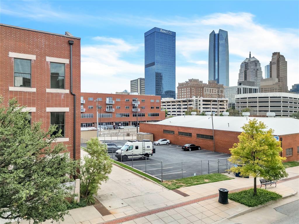 This luxury property overlooking downtown Oklahoma City is uniquely designed with bold features and perfect amenities. This property is unique in that the primary bedroom, living room, kitchen, guest bath, and balcony are all on the same floor. Situated on a corner lot expansive balcony offers a perfect view of the downtown skyline with plenty of space for lounging, seating, and for pets to enjoy the artificial turf. The kitchen boasts designer finishes, including black Dekton countertops and Bosch appliances. Downstairs, you will find a guest bedroom with an attached bath, a large foyer, and an attached two-car garage and coat closet. Additionally, the HOA takes care of Christmas lights in the winter, landscaping, salting driveways, street maintenance, and more. This property offers an incredible opportunity to own a lock-and-leave retreat in the heart of OKC that stands out from the surrounding properties as a one-of-a-kind build.