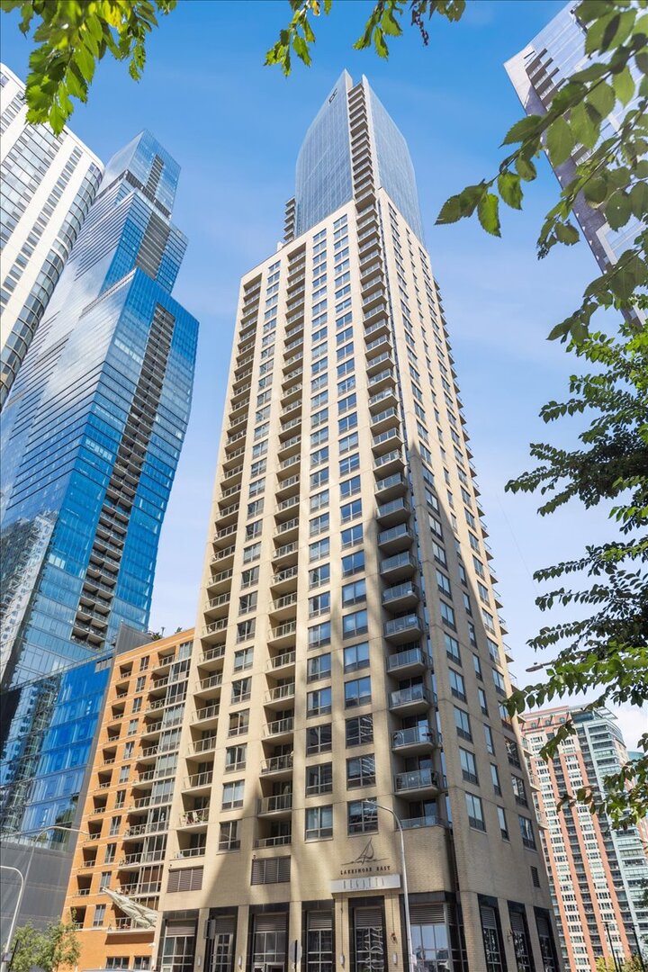 Experience luxury living high above the city at The Regatta in the peaceful Lakeshore East neighborhood. Perched in the penthouse tower of this iconic high-rise, Unit 4010 boasts an extraordinary amount of living space along with sweeping 360-degree views from wraparound floor-to-ceiling windows in every room. Two nice-sized private balconies offer outside space with gorgeous views of the river and lake. The extra-large living room incorporates space typically closed off in this tier as a third bedroom or den. It can be easily enclosed if desired. A spacious dining area could comfortably seat 8-12, and the stylish kitchen offers both a breakfast bar and space for a cafe table...with a river view, btw! The expansive primary suite features a dressing room-sized walk-in closet, and a spa-like bathroom with two vanities, soaking tub, walk-in shower, and water closet. The size of the primary bedroom offers the owner the possibility of also adding in an office area, workout space, or...? The split floor plan places the second bedroom almost in a "private wing" with its own entrance, full bath, and wall of double closets. High ceilings, hardwood floors, and panoramic views add to the elegance. (Make sure you see the stunning nighttime photos that were just taken from this unit that show the river, the lake, and the fireworks from Navy Pier.) A pretty powder room, side-by-side washer/dryer, and large front hall closet add to the convenience. The Regatta's 5000 square feet of top-tier amenities include an indoor pool with hot tub, well-appointed fitness center, newly remodeled party room, library, children's playroom, 13th floor sundeck with grills, and more. Set in the tranquil Lakeshore East neighborhood with its lovely park, you're moments from the vibrancy of Millennium Park, Grant Park, Michigan Avenue, the Theatre District, and of course, the lakefront. Mariano's is a 10-minute walk away. Deeded garage parking valued at $45K is included in the asking price-though you may never need to drive anywhere! This is easy city living at its best!