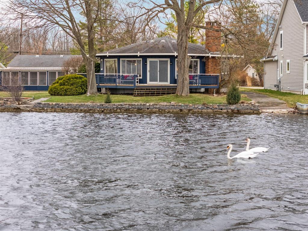 Mid-Century Modern Tetradecago (14-sided) cottage on Portage Lake! This one-of-a-kind lakefront retreat isn't just a home--it's a conversation piece. Set on a rare .254-acre lot with 98 feet of prime Portage Lake frontage, it's one of only 10 properties on Colony Road not located on a canal--hello, wide-open water views! Built in 1963, the striking 14-sided design delivers serious architectural flair. The 1,736 sq ft main cottage offers 2 bedrooms and 1 full bath, while the separate bunkhouse adds flexible sleeping space and a second full bath--perfect for guests, lake weekends, or overflow fun. The dreamy screen room is your front-row seat to sunsets, breezes, and everything you love about lake life. Stylish, rare, and unforgettable--this is MCM magic on the water.