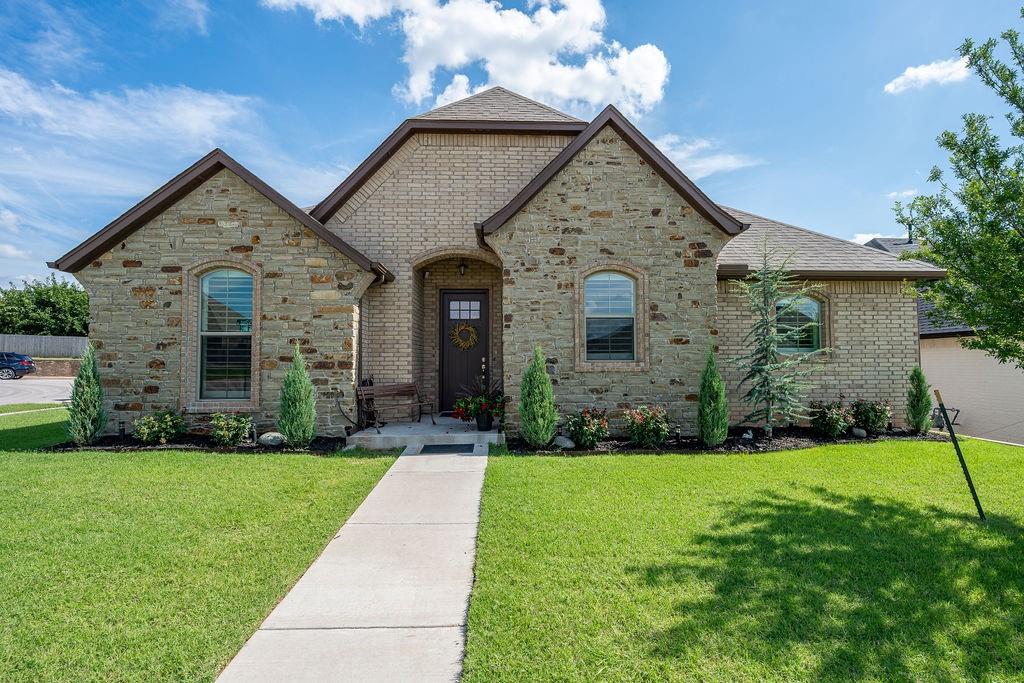 Welcome to this Beautifully Designed and Thoughtfully Appointed Home! From the moment you arrive, you’ll appreciate the well-maintained exterior. Step inside to find tall ceilings and an open, inviting layout that instantly feels like home. The beautiful entryway leads you into the heart of the home—a light-filled living, kitchen, and dining area designed for both relaxing and entertaining. The stunning fireplace adds a touch of modern charm, while elegant lighting creates a warm and welcoming atmosphere. There is a dedicated study with views into the living area, but tucked away with French doors for privacy.  The kitchen is as practical as it is stylish, featuring sleek quartz countertops, stainless steel appliances, a walk-in pantry, and a generous island that offers both prep space and additional seating. Nestled away at the back of the home, the primary suite provides a peaceful retreat with a large ensuite bathroom that includes a dual-sink vanity, a beautiful tub, and a tiled walk-in shower.  Two additional bedrooms share a well-sized bathroom.  Step out back to enjoy a large covered patio and a fully fenced private backyard with plenty of room to spread out (and wooded behind), with an additional concrete pad for a secondary outdoor living space, or to park your trailer!  Located near the Kilpatrick Turnpike, this home offers quick access to dining, shopping, and minutes from Chisholm Creek. Call today for your private showing!