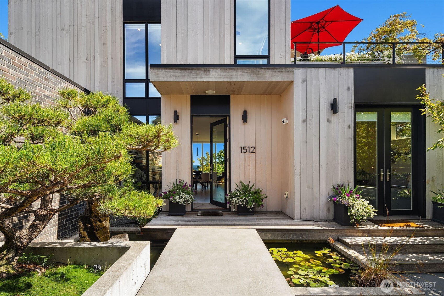 Exceptional Modern home built in 2019 with drop-dead views of Lake Washington, Mt. Rainier and the Cascades. Sited at the crest of Mt. Baker Ridge, this distinctly custom residence enjoys a rare “top of the world” outlook, with eastern & western exposure and leafy green surroundings. A private courtyard entry welcomes you with a Japanese-inspired water feature and specimen pine tree, setting the tone for the sophisticated architecture within. Expansive walls of glass, tall ceilings and an old-growth fir-lined ceiling, create a dramatic yet inviting main level. The striking kitchen features premium SieMatic cabinetry, leathered quartzite counters, a 12-foot waterfall island and a 10.5’ folding glass wall that opens to the outdoors. The dreamy primary suite offers a luxurious marble bath, walk-in closet & infinity views. A partially covered roof deck is an extraordinary entertaining destination with sweeping views, lush planters, fire pit & hot tub. The light-filled lower level features a permitted 2-bed/2-bath ADU with direct access to the private yard and bocce court—ideal for guests, work, gym or rental income. Radiant heat, A/C, gas fireplace, motorized shades and Lutron lighting, ensure effortless comfort. An attached garage with EV charging and smart-home technology completes the lock-and-go ease. Walk to neighborhood cafés, restaurants, Lake Washington & light rail for convenient access to downtown & the Eastside. This home is for those who appreciate the difference!