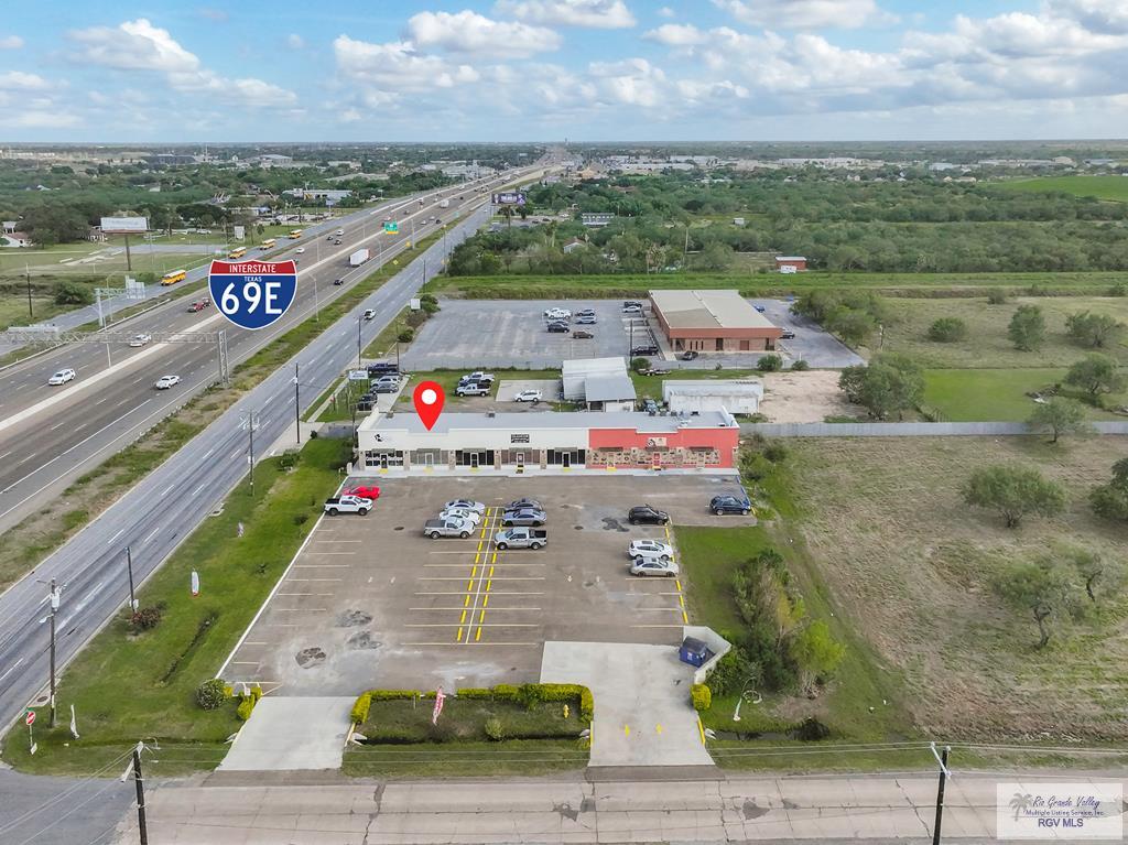 Reduced!!Great Commercial building with a total of 8 units which includes 1.29 acres next door that can be developed as commercial.  5 units are presently rented and are long time tenants.  Parking lot and plaza sits on 1 acre. Don't miss out on this investment opportunity!!
