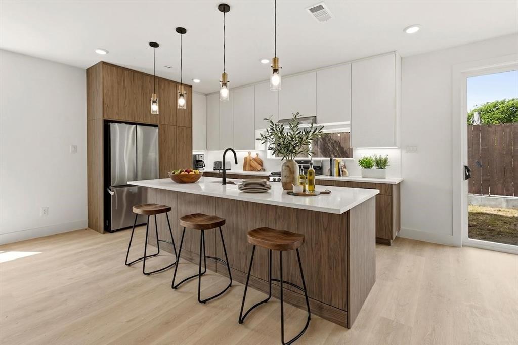 Modern new construction just minutes from Bishop Arts. This 3-bedroom, 4-bath home with a FLEX ROOM on the first floor- offers three levels of thoughtfully designed living with stunning Dallas skyline views from the upper level. Bright, open-concept interiors feature wide-plank wood flooring, oversized windows, designer lighting, and sleek modern finishes throughout. The spacious kitchen flows seamlessly into the main living and dining areas, creating the perfect setup for entertaining or everyday living. Private bedrooms each offer en-suite baths, while the primary suite features a spa-inspired bath and generous walk-in closet. Enjoy the convenience of a low-maintenance lifestyle paired with unbeatable access to Bishop Arts dining, shopping, nightlife, and Downtown Dallas. A rare opportunity to own stylish city living with elevated views.