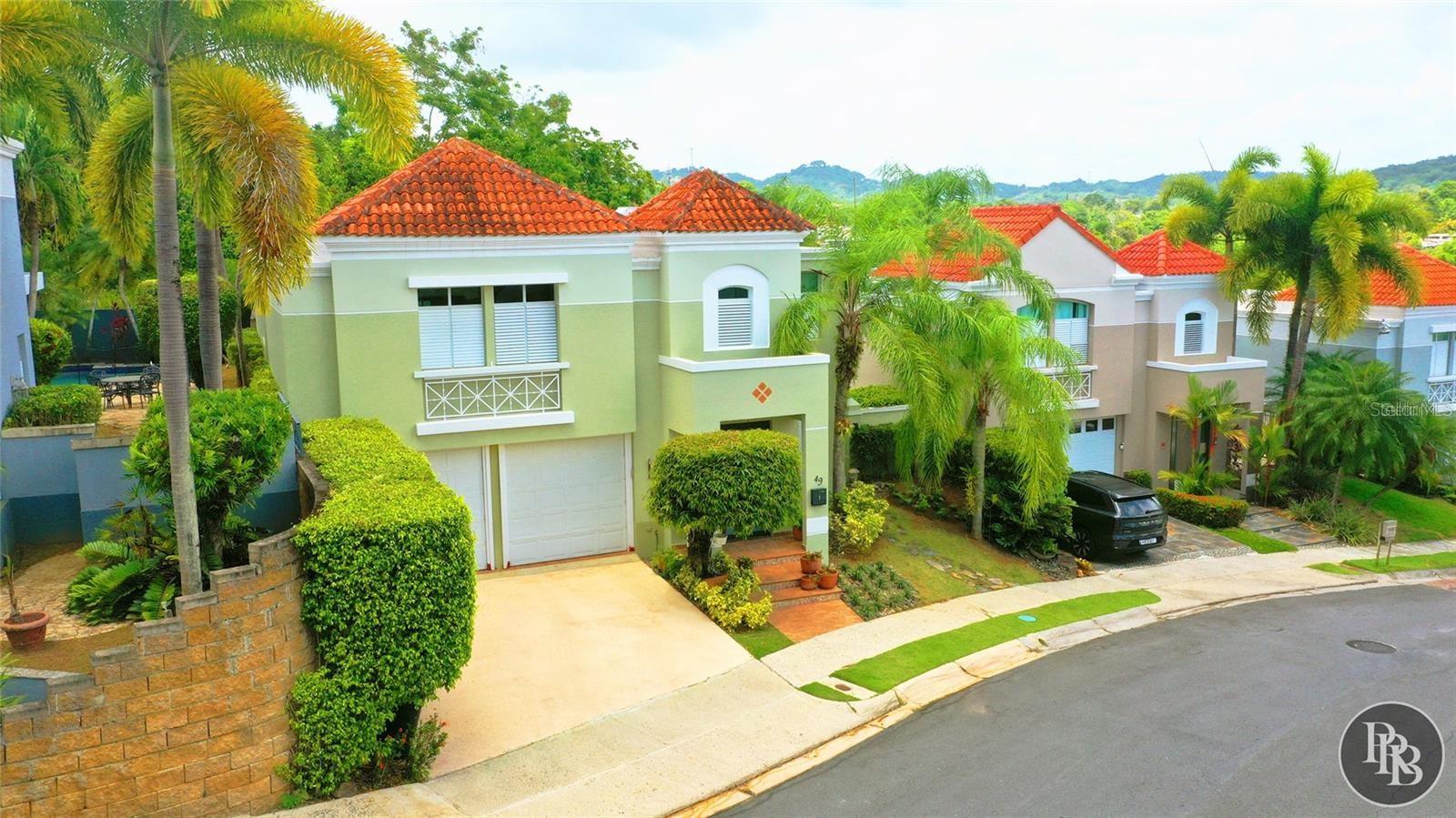 Experience the perfect blend of comfort, privacy, and Caribbean living in this beautiful residence located in the desirable Monte Verde Real gated community. This thoughtfully designed home features soaring double-height ceilings, abundant natural light, spacious living areas, and an inviting open layout perfect for everyday living and entertaining. The remodeled kitchen serves as the heart of the home, showcasing granite countertops, a center island, stainless steel appliances, and elegant cabinetry, creating a stylish and functional space for family gatherings. Step outside and enjoy a private tropical retreat featuring a pool, covered terrace, decorative fountain, stone decking, and lush landscaping. The outdoor spaces provide the ideal setting to relax, entertain guests, and embrace Puerto Rico’s year-round lifestyle. Monte Verde Real offers a secure and welcoming community lifestyle with 24-hour guard service and amenities including tennis courts, clubhouse, fitness facilities, playground, community pool, and recreational areas. Conveniently located with access to PR-199, this home provides easy connectivity to schools, healthcare, shopping, dining, and premier destinations throughout San Juan, including Plaza Las Américas and The Mall of San Juan. A unique opportunity to enjoy elegant interiors, resort-style outdoor living, and the comfort of one of San Juan’s most established residential communities.