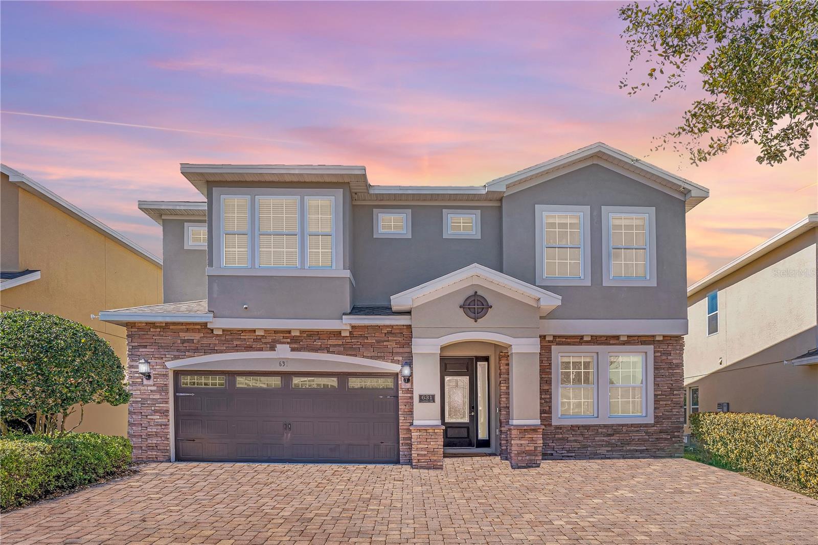 DESIGNED TO IMPRESS. POSITIONED TO PERFORM.Welcome to this exceptional 10-bedroom, 10-bath luxury retreat in the highly sought-after Encore at Reunion - just minutes from Orlando’s world-renowned theme parks and projected to generate $120,000 in annual income.Sold FULLY FURNISHED and completely TURNKEY, this 4,730 sq ft residence is crafted for elevated group travel and consistent rental demand. Featuring 9 private ENSUITE bedrooms, including FOUR PRIMARY SUITES (two downstairs and two upstairs), the layout delivers privacy, flexibility, and comfort at scale. Every closet includes custom built-in shelving, adding thoughtful organization throughout.What truly sets this home apart is its IMMERSIVE “WORLD SHOWCASE INSPIRED - AROUND THE WORLD” design concept; each bedroom carefully curated to transport guests across iconic destinations. From the historic charm of Philadelphia to the timeless sophistication of London, the skyline energy of Manhattan, the Mickey Inspired Orlando suite, the bold glamour of Vegas, the icy enchantment of Arendelle, and the romance of Paris - every space is layered with custom murals, curated décor, and thoughtful design elements that create a stay guests remember long after checkout. This intentional theming enhances booking appeal, guest experience, and repeat revenue.The OPEN-CONCEPT living space invites connection, flowing into a gourmet kitchen built for entertaining with granite counters, 42” shaker cabinetry, dual stainless steel refrigerators, dual dishwashers, and a dedicated coffee bar. Upstairs and downstairs laundry suites plus two Owner’s Closets provide seamless management and owner convenience.Entertainment is effortless. The interactive STAR WARS INSPIRED GAME ROOM features ping pong, air hockey, and foosball, while the private THEATER ROOM sets the stage for cozy movie nights after a day at the parks. A dedicated WORK-FROM-HOME-STATION accommodates extended stays with ease.Outside, your private resort oasis awaits, complete with a HEATED POOL AND SPA, expansive paver lanai, fenced tropical backyard, and a NEW high-rated insurance-compliant pool safety fence with self-closing, self-latching gate for added peace of mind.Major value-enhancing upgrades include a NEW ROOF (2025), FRESH INTERIOR PAINT (2026), two newer refrigerators (2024 & 2025), new upstairs washer (2024), tankless water heaters, and dual A/C systems - providing durability, efficiency, and insurance advantages. Curb appeal shines with a stone façade, paver driveway, and epoxied garage floor.Encore at Reunion delivers premier resort living with access to a 10-acre waterpark with exhilarating slides, splash pad, poolside cabanas, fitness center, courts for tennis, volleyball and basketball, a full soccer field, casual on-site dining and bar, a concierge desk, and shuttle transportation to the parks - all within walking distance. HOA includes gated security, internet, cable, landscaping, irrigation, daily valet trash, pest control, and community maintenance - supporting simplified ownership. This is more than a vacation home - it’s a powerful blend of LIFESTYLE and INCOME. With tourism growth and major park expansions continuing to fuel demand, this property is positioned to perform and provide the opportunity to create cherished moments with loved ones while paying for itself.Schedule your private showing today and secure your position in one of Central Florida’s most desirable vacation rental communities!