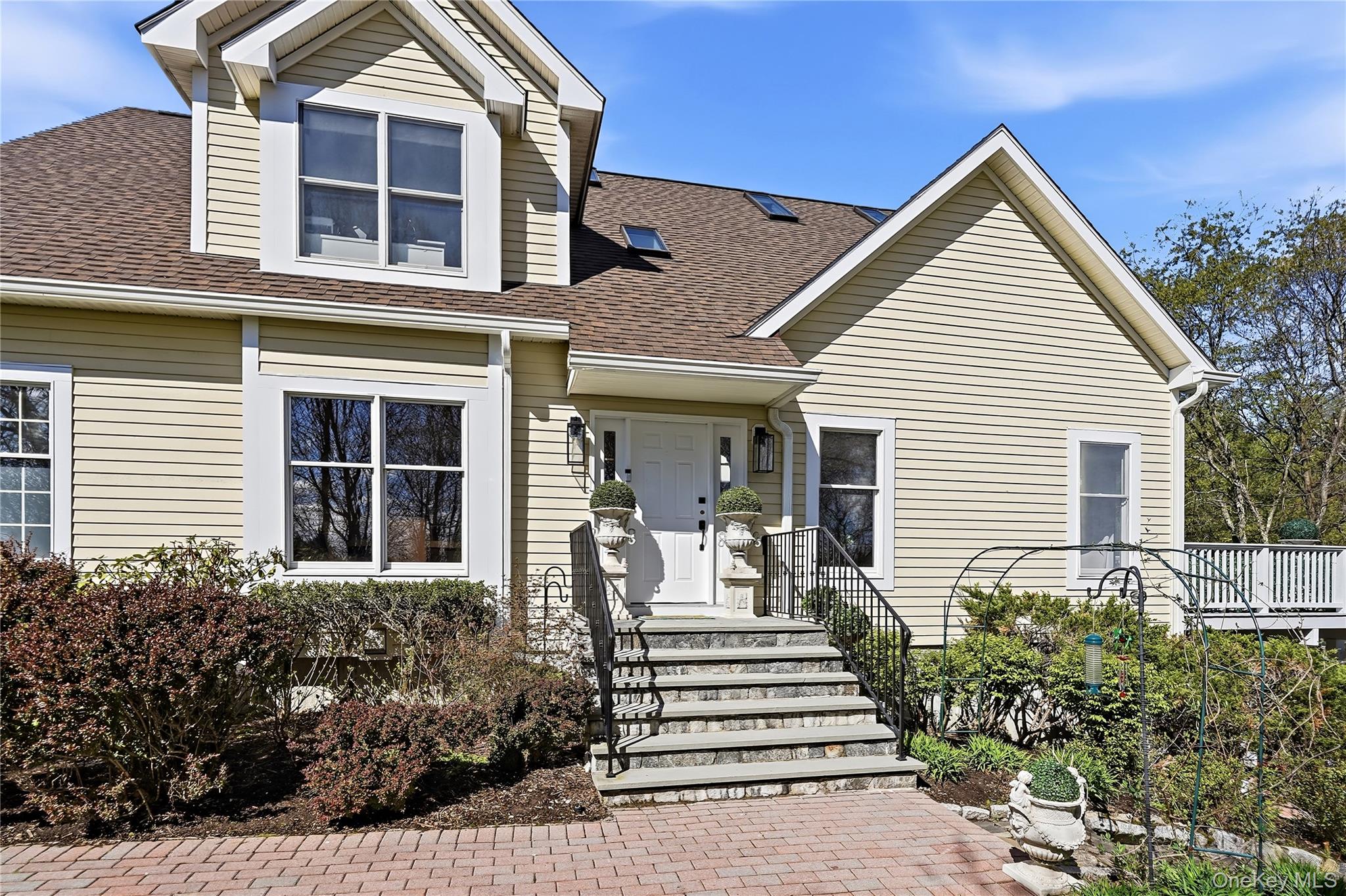 Beautifully renovated and completely turnkey, this four-bedroom residence is ideally situated in the highly sought-after gated community of Whippoorwill Hills, within the Byram Hills School District. Offering the ease of maintenance-free living paired with resort-style amenities—including tennis and pickleball courts, basketball, swimming pools, a playground, and clubhouse—this home delivers an exceptional lifestyle year-round. This coveted Rockland model features a thoughtfully reimagined main level, highlighted by a stunning first-floor primary suite. Completed in 2022, this serene retreat includes custom California Closets and a spa-inspired bath with an elegant walk-in shower. The main floor also offers a formal dining room, a sun-filled living room with a vaulted ceiling and direct patio access, and an eat-in kitchen with breakfast bar seating and a walk-in pantry. A beautifully renovated powder room (2022), convenient laundry area, and effortless one-step entry to the two-car garage complete this level. Upstairs, you’ll find three additional bedrooms, including a second primary suite with a luxurious spa-style bath, along with a beautifully appointed full hall bathroom. Rich oak select flooring extends throughout both the first and second levels.  The 768 sq foot walk out lower level (included in total) delivers exceptional versatility, offering ample space for entertaining, recreation or fitness. Recent updates include a new hot water heater (2025), AC condenser (2023), Miele dishwasher (2022), gutters with leaf guards (2025), and a newly installed lower-level brick patio (2023). The community replaced the roof in 2025. Perfectly positioned at the end of a quiet cul-de-sac, this pristine and sophisticated home also offers the convenience of a very short walk to the shops and dining of downtown Armonk. The impeccable high end renovations will surely impress the most discerning buyer.