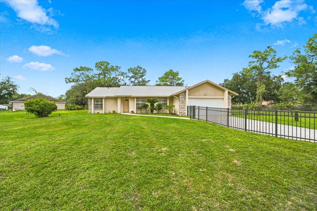 Discover Comfortable Living, Acreage, and an Active Florida Lifestyle in Wesley Chapel!Welcome to 26953 Coral Vine Lane, where comfort, convenience, and the freedom of owning acreage come together! Situated on over an acre of land with NO HOA, this beautifully maintained Wesley Chapel home offers a wonderful opportunity to enjoy extra space, a private screened-in pool, and the Florida lifestyle you've been looking for—all while remaining conveniently located near shopping, dining, and everyday essentials.Step inside to discover inviting living spaces, a functional kitchen, and a comfortable layout designed for everyday living, with gleaming wood floors adding warmth and character. The charming wood-burning fireplace creates a welcoming gathering place for cozy evenings, game nights, holiday celebrations, or simply relaxing with a good book. Whether you're entertaining guests, enjoying quiet time, or working from home, this home offers flexibility for a variety of lifestyles.Explore outside and imagine the possibilities! With over an acre of land, there's plenty of room to spread out, play outdoors, enjoy lawn games, pursue gardening interests, or simply appreciate having more space around you. Imagine afternoons filled with outdoor activities, friendly games, and backyard gatherings! The private pool, surrounded by a large screen enclosure, creates your own backyard retreat. Enjoy morning coffee poolside, afternoon swims, weekend cookouts, or evenings relaxing with friends. The combination of generous acreage and NO HOA makes this property especially appealing to those seeking additional outdoor space without HOA fees.Recent improvements include a roof replacement (2023), A/C (2021), water heater (2020), water softener (2022), pool pump (2022), and septic system and drain field (2022). A Generac generator added in 2024 offers an additional level of preparedness and convenience. Also included in the sale are the Ring doorbell, HIK security camera system, and upright Frigidaire freezer located in the garage.Love the outdoors? You'll love the location! Convenient access to the nearby well fields, scenic biking and walking routes, and green spaces makes it easy to enjoy morning walks, afternoon bike rides, and Florida's beautiful weather.Enjoy the best of both worlds—the space and flexibility of acreage living with the convenience of Wesley Chapel! Shopping, restaurants, entertainment, fitness facilities, medical services, and everyday necessities are all within easy reach. Convenient access to major roadways makes commuting and exploring the greater Tampa Bay area a breeze.Whether you're looking for room to spread out, a place to entertain, an outdoor retreat, or simply a home with more breathing room, 26953 Coral Vine Lane offers a wonderful combination of space, comfort, and convenience.Over an acre, NO HOA, a screened-in pool, a wood-burning fireplace, and valuable recent improvements—come discover the possibilities! Schedule your private showing today!