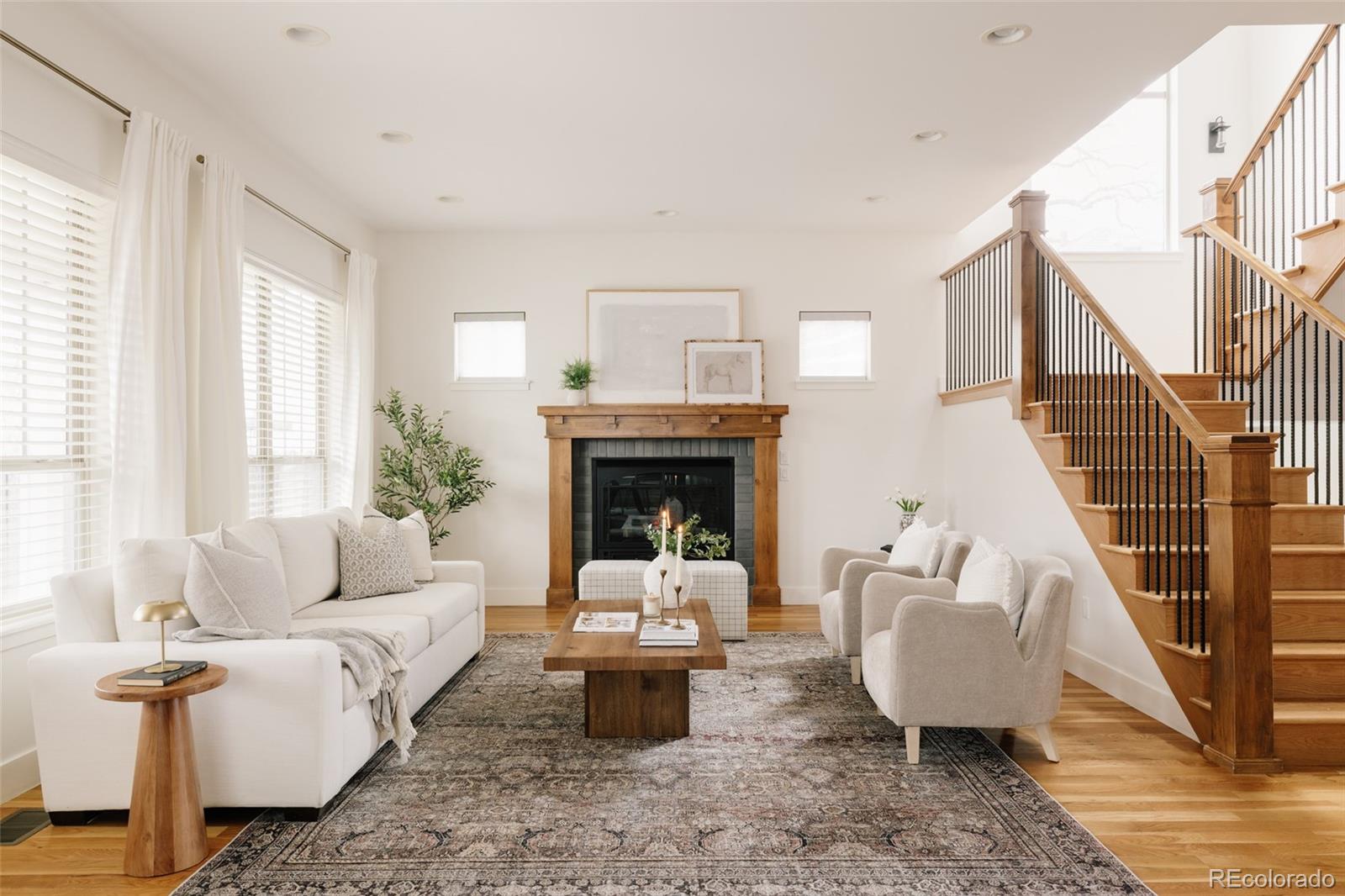 Perched on an elevated lot with easy access to Platt Park, Wash Park, and surrounding neighborhoods, this custom residence delivers scale, light, and a level of finish rarely found. The main living space is expansive and bright, anchored by soaring ceilings, wide-plank white oak floors throughout the main and second floor, and oversized windows that flood the home with natural light. The living room centers around a fireplace and flows effortlessly into the kitchen, creating a cohesive environment for daily living and entertaining. The kitchen has been thoughtfully refreshed with new quartz countertops, designer lighting, and a high-end appliance suite including Miele, JennAir, and Sub-Zero, all oriented around a substantial island. A walk-through butler’s pantry with prep space connects to the formal dining room for a polished hosting experience. Just beyond, a dedicated main floor office with custom built-ins provides a refined workspace. A large mudroom completes the main level. Upstairs, four bedrooms on one level offer a layout that is increasingly rare. The primary suite is a standout with a fireplace, chandelier, and mountain views. The ensuite bath features dual vanities, a soaking tub, large shower, and a spacious walk-in closet. One secondary bedroom serves as a private guest suite with its own ensuite bath, while two additional bedrooms are supported by a full hall bath with a separate water closet. A centrally located laundry room adds convenience. The finished basement offers tall ceilings, a large recreation space, a custom display room ideal for whiskey, wine, or a library, plus an additional bedroom and full bath. The backyard is private and usable, while the detached three-car garage with additional off-street parking is a rare offering, providing exceptional space for vehicles, storage, or hobbies. Wide, substantial, and intentionally designed, this home offers a rare combination of volume, layout, and finish in a premier Denver location.