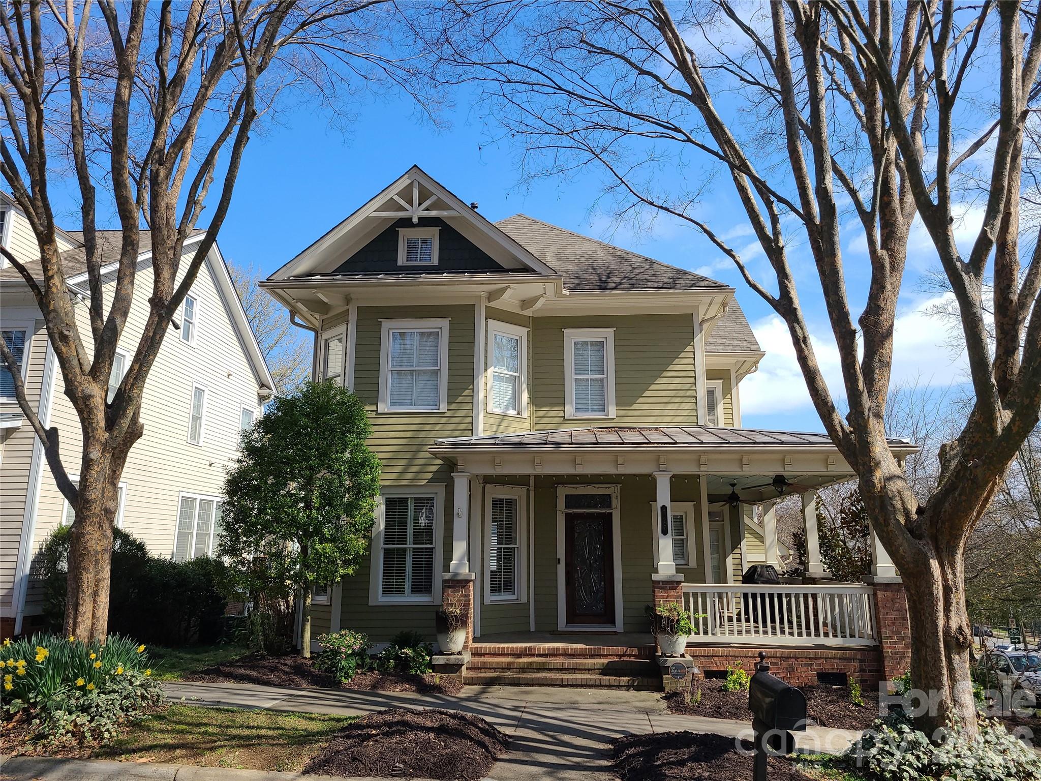 This Single Family New Charleston Style Home offers the rare combination of Suburban Living with the Uptown Lifestyle. Ideally situated on a corner lot overlooking the community green space of Linear Park, this beautifully maintained 3 bedroom, 2 1/2 bath home offers a rare combination of space, privacy, and convenience just minutes from the heart of Uptown Charlotte. The kitchen features granite countertops, timeless subway tile backsplash, stainless steel appliances, and a gas range, opening seamlessly to the living and breakfast areas. A cozy living room fireplace adds warmth and character to the living space. Welcome guests from the inviting wraparound front porch, where skyline views and landscaped surroundings create the perfect setting for morning coffee or evening relaxation. The primary suite offers a luxurious retreat with dual granite vanities, a beautifully tiled glass shower, a generous walk-in closet with built-ins and heated bathroom floor. A rare two-car attached garage provides valuable parking and storage in the heart of Uptown, with additional driveway parking. Additional street parking passes are available through the City. The home also offers attic storage above the garage and thoughtful features throughout, including plantation shutters, a pre wired home sound systemm 1 inch hardwood floors up and down, modern fixtures and irrigation system. Located in First Ward, you're within easy reach of light rail, restaurants, entertainment, parks, shopping, stadiums, Brookshire Freeway and other major arteries and everything Uptown Charlotte has to offer. Refrigerator, Porch Furniture and Grill will convey with property. Alleyway in rear for access to driveway is maintained by HOA.