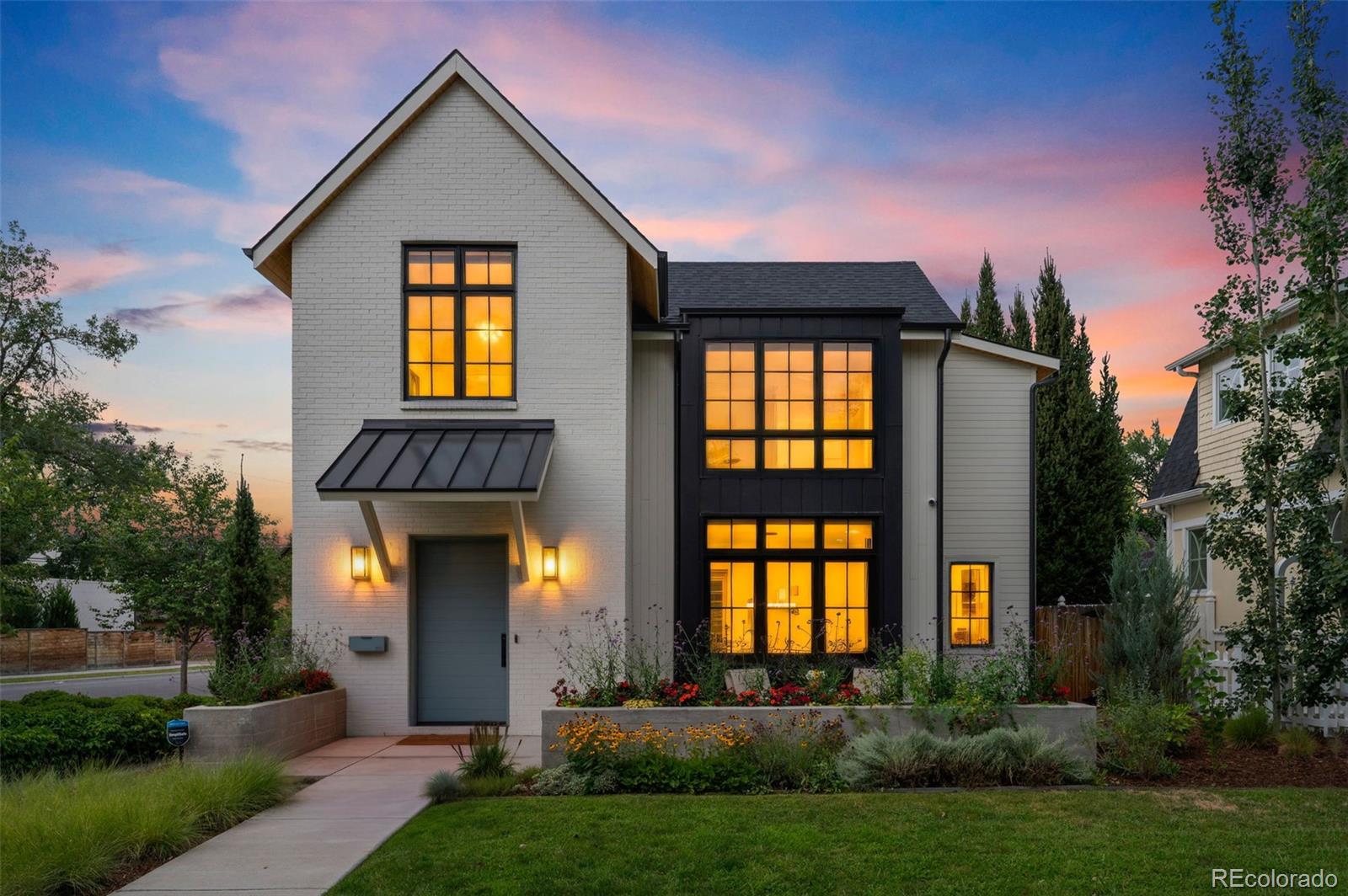 Designed by acclaimed Alvarez Morris and fully realized by Studio Thomas, this exceptional East Wash Park residence brings architectural distinction, sophisticated interiors and true turnkey functionality to a sun-drenched corner lot. Every element has been considered, creating a level of warmth, polish and livability rarely found in a new build. The main level features elevated fixtures, wide-plank white oak floors, eight-foot doors and distinctive shiplap detailing. The sleek chef’s kitchen is outfitted with a 48” Wolf range, Sub-Zero refrigerator, dual dishwashers, custom cabinetry, butler’s pantry and hidden walk-in pantry. A private office through the formal dining room is defined by steel-framed French doors. Expansive bifold doors connect the great room to an exceptional outdoor living space with a built-in grill, pizza oven and concrete firepit, while a heated, aluminum louvered pergola extends the space for year-round entertaining. Professionally landscaped grounds further enhance the seamless relationship between architecture and landscape. The showstopping primary suite pairs architectural presence with refined materiality, featuring an exquisitely appointed five-piece marble bath with Rohl fixtures, soaking tub and steam shower. Two additional en-suite bedrooms and a convenient laundry room complete this level. The lower level includes a gym, guest suite and expansive recreation room with a sophisticated wet bar and temperature-controlled wine display. Integrated technology includes whole-home built-in AV. Fully owned solar panels and Tesla Powerwall provide exceptional energy efficiency. Ideally located in the heart of Washington Park, this extraordinary residence is just moments from the park and within walking distance of the shops and restaurants along Gaylord and Bonnie Brae. A rare opportunity to own a nearly new home elevated beyond the expected, with architecture and interiors conceived as one cohesive expression of design, style and livability.
