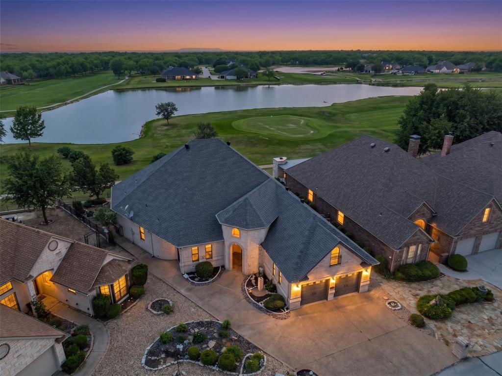 Nestled on the Nutcracker Golf Course in the gated community of Pecan Plantation, this low-maintenance gem sits on a quiet cul-de-sac & makes an unforgettable first impression. The striking tower-style entrance, light stone & brick exterior & bold dark garage doors create standout curb appeal that sets the tone for everything inside. Step through the rich wood front door into soaring ceilings & an elegant staircase that draws your eye upward — leading to a versatile unfinished attic space ready to become your bonus room, studio, or storage haven. Crown molding graces the living areas, where a dramatic floor-to-ceiling stone fireplace anchors the room & large picture windows frame sweeping views of the golf course: a view you'll never tire of. The spacious kitchen is a true entertainer's dream, featuring granite countertops, a center island, breakfast bar seating, stainless appliances, a dedicated dining area & more storage than you'll know what to do with. A half bath serves guests & oversized laundry room with even more storage to keep life organized. Retreat to the expansive primary suite, complete with an ensuite featuring: dual sinks, vanity seating, a walk-in shower, a jetted tub & a generous walk-in closet. A second large bedroom & a full bath provides comfortable space for guests, while a dedicated office gives you the quiet workspace you deserve. Out back, enjoy your covered porch spanning nearly half the length of the home — perfect for morning coffee or evening sunsets over the course. The fully fenced yard features a low-maintenance rock landscape with raised garden beds for your green thumb moments. A two-car garage plus a dedicated golf cart garage complete this thoughtfully designed home. As a resident of Pecan Plantation, you'll enjoy 24-7 gated security and an unparalleled lifestyle: golf, multiple swimming pools, tennis & pickleball courts, fine dining, a pharmacy, bank, car wash & even a full-service grocery store, all within the gates.