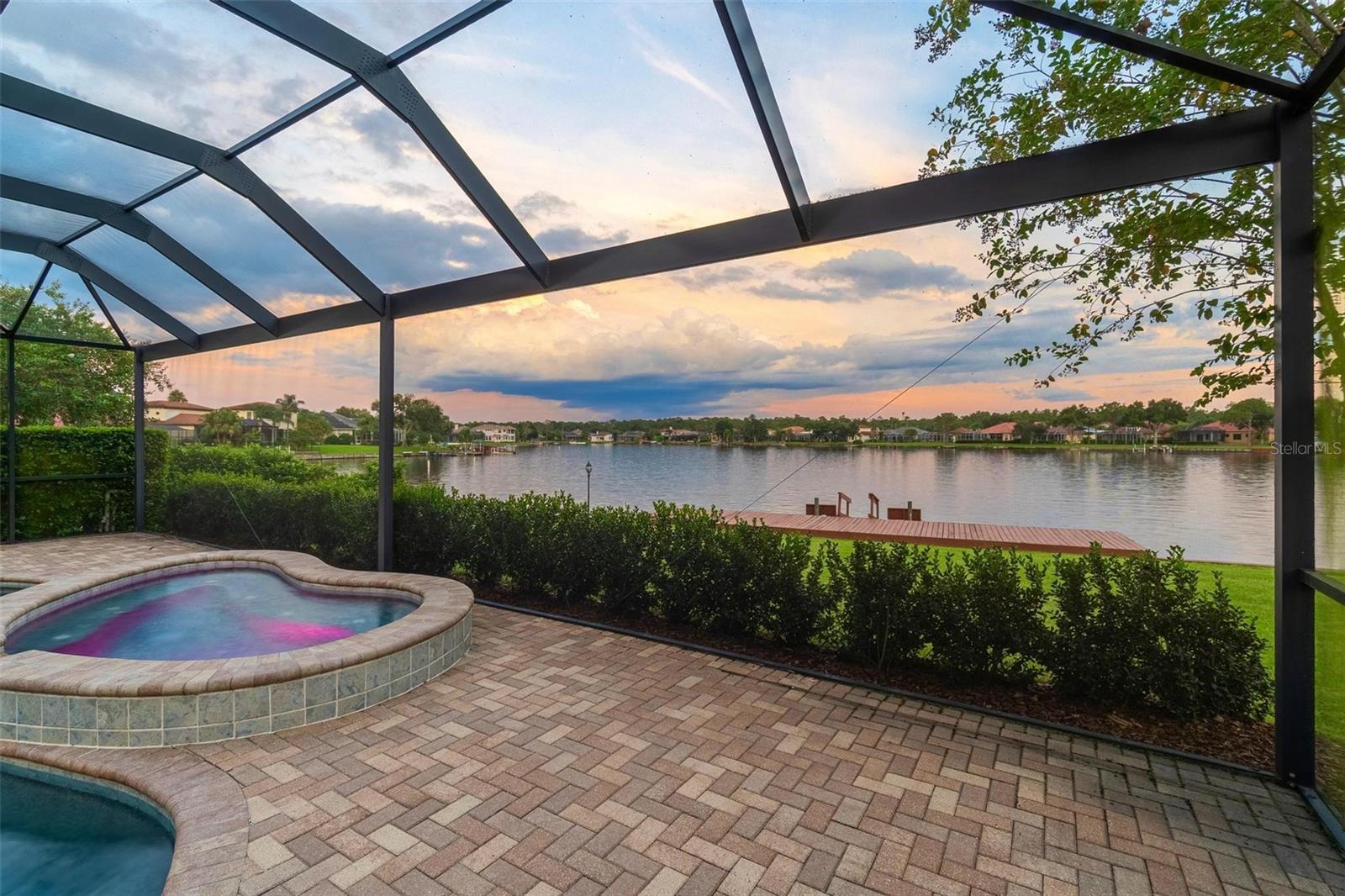 Welcome to 10521 Bermuda Isle Drive, an exquisite 4-bedroom, 4-bathroom home nestled in the prestigious Cory Lake Isles of Tampa, Florida. Boasting 3,731 square feet of luxurious living space, this residence is situated on the expansive section of Cory Lake, offering breathtaking water views and direct lakefront access.

Step inside to discover a home that marries elegance with modern updates. The property has received over $250k in enhancements, including a new roof in 2021, three efficient AC units (two installed in 2017 and one in 2023), and all-new hurricane impact windows, doors, and garage doors from 2019, newly updated pool and spa heaters, also from 2019.

The interior impresses with amazing dual pocket doors in the living area allowing the outside in, expansive tile flooring throughout, a home office with custom built ins, a downstairs secondary en suite bedroom, and a beautifully updated primary suite with spacious bath and dual walk in closets. Enjoy cooking in the well-appointed kitchen, complete with a huge walk in pantry and contemporary stainless steel applicance and granite counters. The spacious rooms flow seamlessly, providing ample space for entertaining or unwinding. 

Outside, the private pool invites you for a swim, with both pool and spa heaters (all conveniently controlled from your phone) and brand new hurricane rated pool cage with minimal bars offering amazing views of the lake.  Sitting on a huge lot as well offering plenty of backyard fun at .41 acres.  This home truly embodies the Florida lifestyle and is ready to welcome new owners who appreciate the perfect blend of comfort and entertainment. Cory Lake Isles features a 165 acre ski lake, resort style pool, amazing clubhouse with gym, basketball court, tennis courts, outdoor roller hockey, sand volleyball court, beach side playground. Bring your boating toys for all the fun!