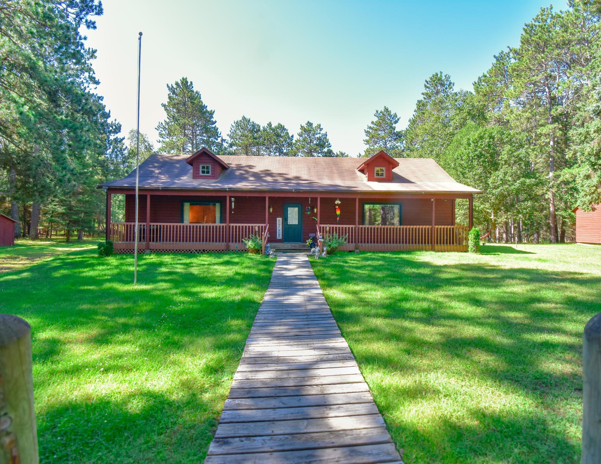 Your Own Private Retreat Near Itasca! This beautiful 16.76-acre property, located on Highway 71 between Park Rapids and Itasca State Park, offers a serene park-like setting. The immaculate home features 3 bedrooms, 1.5 baths, three decks, and a large flex room with vaulted ceilings. A 32 x 24 bunk house with a basement adds extra space for guests or storage. Enjoy the tranquility of towering pines and a meticulously manicured yard—perfect for your escape to nature.