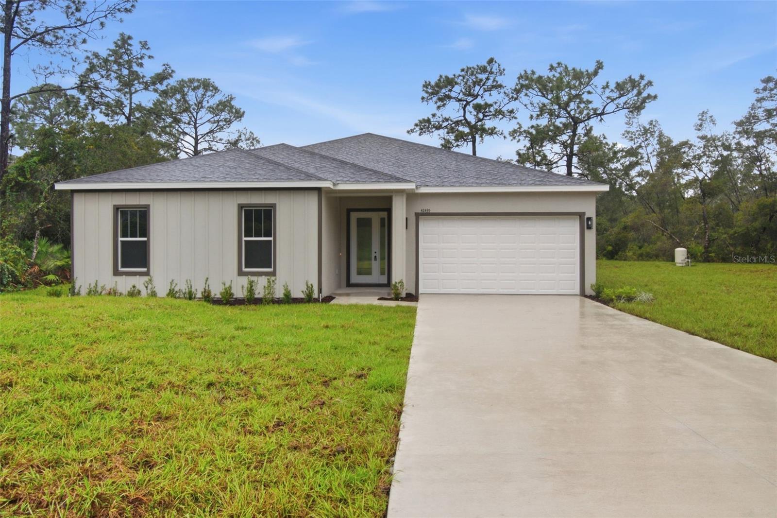 Experience the appeal of brand-new construction in Royal Trails, a unique Eustis community known for its spacious homesites and outdoor recreation! Set on 0.75 acres, this 4-bedroom, 2.5-bathroom home combines modern design with thoughtful details, including custom wood shelving and upgraded appliances that add both style and functionality. The well-designed layout offers comfortable living spaces with room to gather, entertain, and spread out, while four bedrooms provide versatility for a variety of needs. The generous lot opens the door to endless possibilities, whether you envision adding a pool, creating an outdoor entertaining area, building a workshop, or simply enjoying the extra space and privacy. Royal Trails offers a distinctive lifestyle with equestrian and recreational trails, a community park, and a private boat ramp providing access to Lake Norris. Outdoor enthusiasts will appreciate the Florida National Scenic Trail, which runs directly through the community and offers opportunities to explore the area's natural surroundings. Residents can also take advantage of the community center for gatherings and events. For additional shopping, dining, and entertainment, Downtown Mount Dora is approximately 25 minutes away, while the St. Johns River is about 15 minutes away. With an annual HOA fee of just $92, this property presents an excellent opportunity to enjoy modern construction, room to grow, and access to the recreational amenities that make Royal Trails a sought-after place to call home.