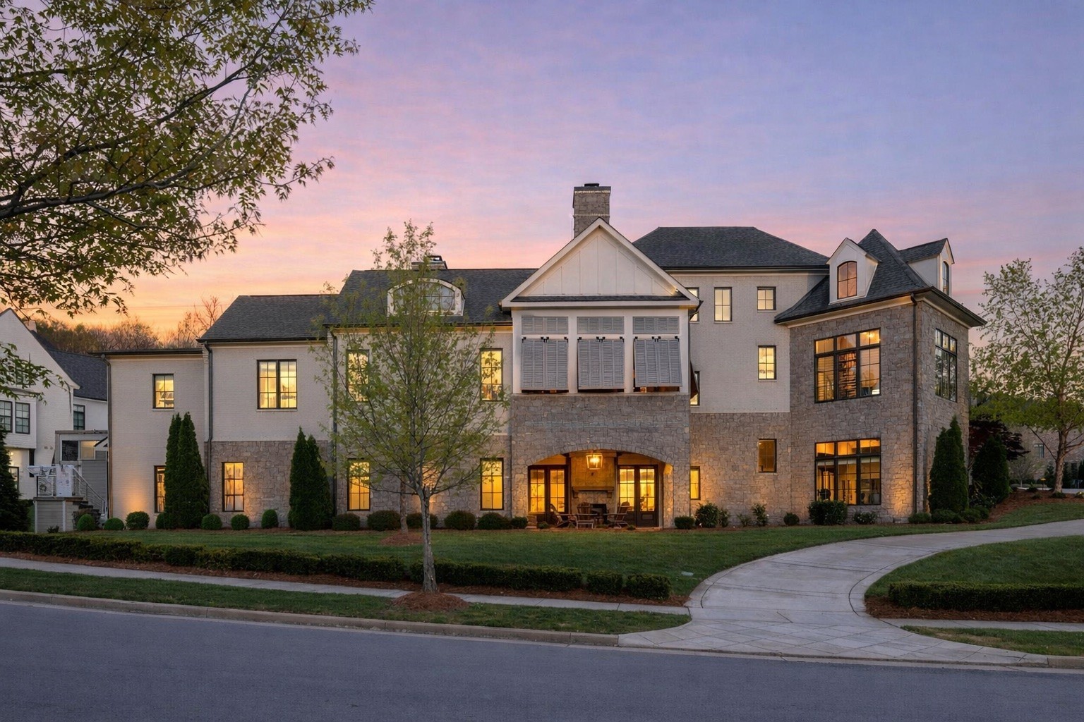 Located in The Avery in Brentwood, TN, this exceptional luxury residence offers nearly 9,000 square feet of refined, spacious living across three levels, including a fully finished basement. Designed to seamlessly blend indoor and outdoor living, the home features 7 bedrooms, 7 full baths, and 2 half baths with elegant, functional spaces throughout. The dramatic main level showcases a grand living room with a stone fireplace, a gourmet kitchen with Wolf cooktop, KitchenAid refrigerator, dual dishwashers, and double ovens, along with a wet bar with ice maker and wine closet-perfect for entertaining. Additional main-level spaces include a private study, dining room, secondary bedroom, and a serene primary suite with fireplace, spa-like bath, and dual walk-in closets. The finished lower level expands the living experience with a fitness room, office/conference space, wet bar, living area, recreation area, additional bedroom, and abundant storage with exterior access. Outdoor living is equally impressive, enhancing the home's seamless indoor/outdoor lifestyle with multiple patios and entertaining areas, including an in-ground pool and spa with firepit, a covered rear patio with fireplace, an outdoor deck with Bahama shutters, and a covered porch off the primary suite also featuring Bahama shutters, as well as an additional lower patio. An attached 4-car garage with epoxy flooring, herringbone brick flooring detail in the drop zone off the garage, and thoughtful storage throughout complete this extraordinary offering of luxury, comfort, and modern design.