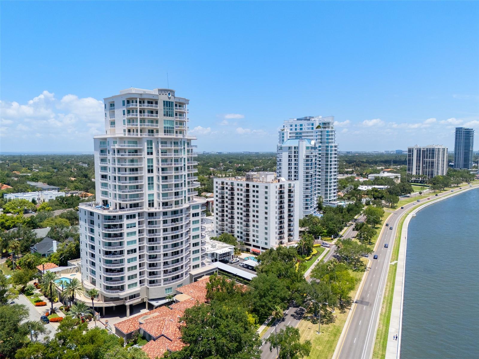 Under contract-accepting backup offers. Available immediately at The Alagon on the prestigious Bayshore Boulevard. Situated with some of the best direct water views in Tampa, along with 4 balconies to enjoy them from, this exceptional three-bedroom, three-and-a-half-bath residence showcases a spectacular backdrop throughout the day. Ideally positioned to capture the beauty of the bay from nearly every angle, this residence offers an extraordinary blend of luxury, comfort and convenience in one of South Tampa’s most desirable addresses. Greeted with a double-door entry, the spacious floor plan features expansive windows and sliding glass doors that flood the home with natural light while framing panoramic views across all the windows and balconies. The generous living and dining areas flow seamlessly together, creating an inviting atmosphere for gatherings large and small. The beautifully updated kitchen is thoughtfully appointed with stunning level 5 quartzite, custom cabinetry, GE Café appliances and a center island, providing style and functionality for the home chef. Each of the three spacious bedrooms serves as a private retreat and includes its en-suite bath, offering comfort and privacy for family members and guests alike. The luxurious primary suite is highlighted by continued bay views, ample closet space and a spa-inspired bath designed for relaxation. Key features include Brazilian hardwood floors throughout, electric shades, upgraded toilets, water softener system, a new water heater, two garage parking spaces, convenient guest parking and a private storage unit. Residents of The Alagon enjoy an impressive collection of resort-style amenities designed to enhance daily living. Community features include sought-after guest suites, a sparkling swimming pool, a well-equipped fitness center, a theater room with updated lounge seating, secure building access, ample guest parking and attentive 24-hour concierge service. The building’s premier Bayshore Boulevard location places residents moments from South Tampa’s renowned dining, shopping, entertainment, parks, downtown Tampa, Water Street, Hyde Park Village and Tampa International Airport.