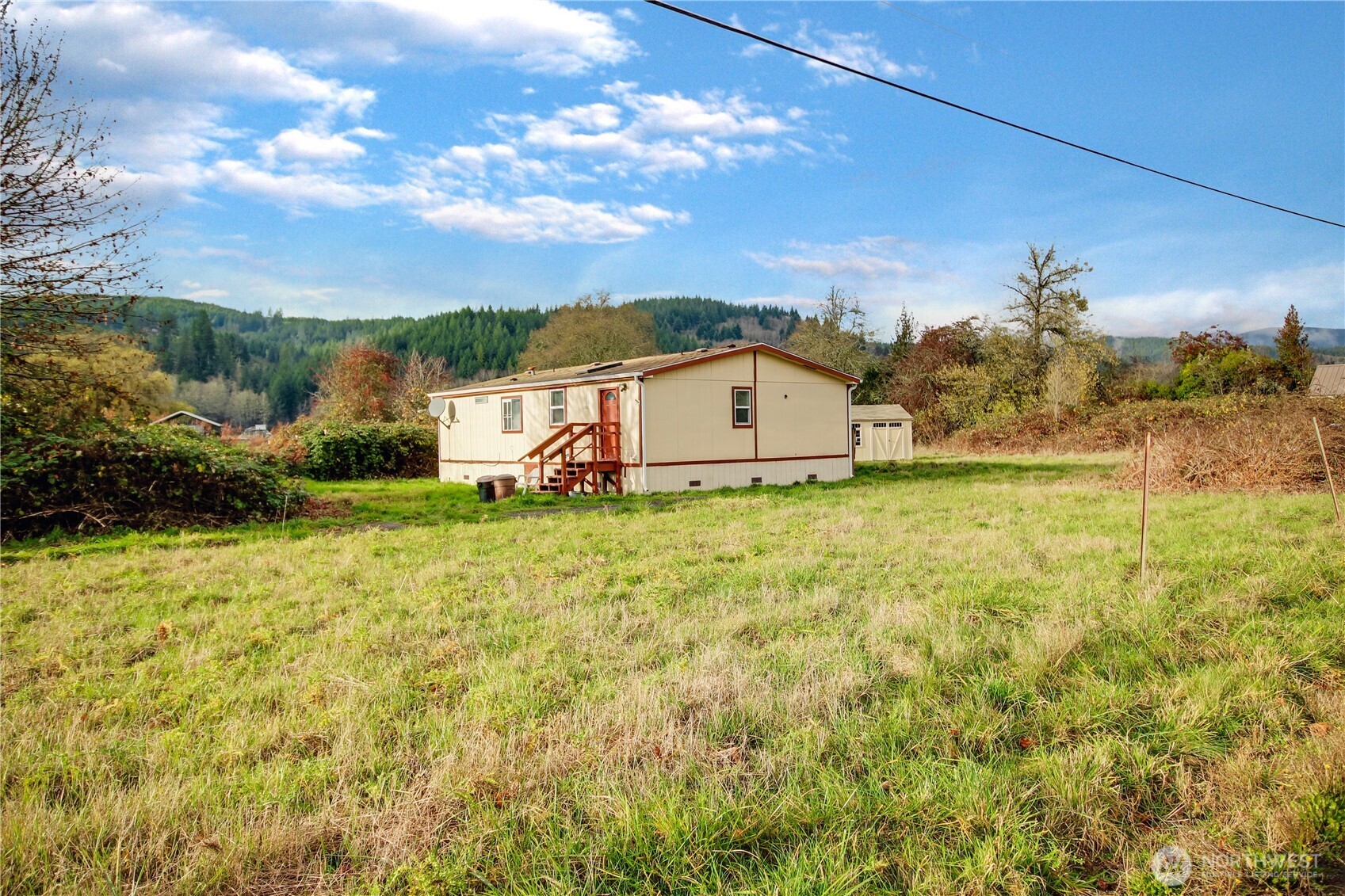 Enjoy peaceful country living on 1.3 acres with this 3-bedroom, 2-bath manufactured home. The property offers a great layout, plenty of outdoor space, and the relaxing sounds of the Elochoman River just across the street. A one-year-old storage shed also provides extra room for tools or equipment. This home is in need of repairs, an opportunity to customize to your style. With room to garden, play, or simply unwind, this acreage offers the tranquility of rural living while still being within reach of town amenities.