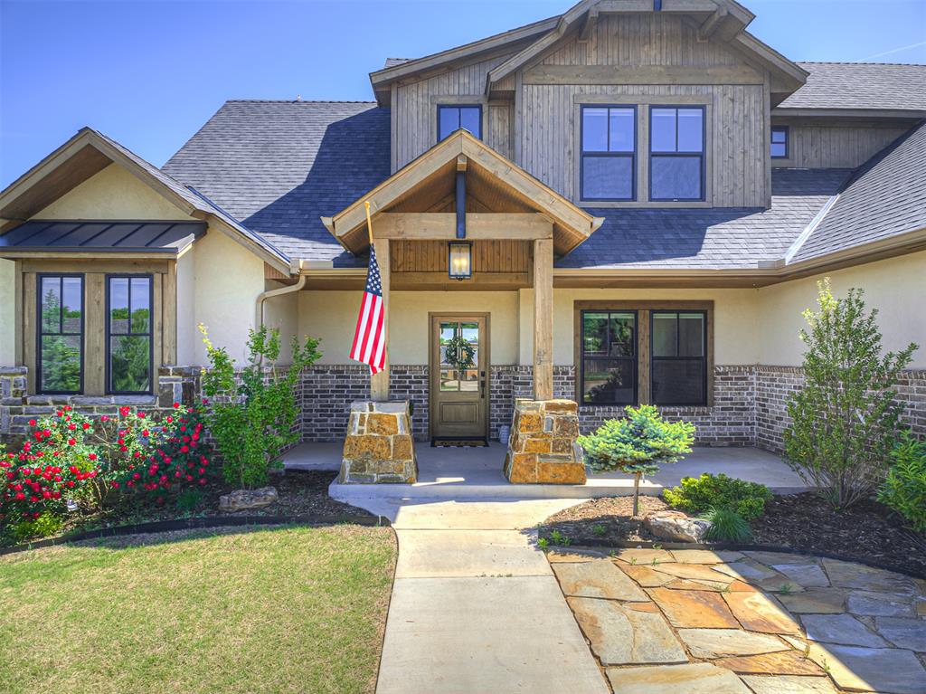 1% credit available via our preferred lender! Former Parade of Homes WINNER in the desirable Edmond School district. Featuring vaulted ceilings, warm wood floors, wood beams, and an open formal dining room perfectly positioned near the entrance — an ideal home for entertaining. The main living is a spacious, light-filled room boasting a stone fireplace with mantle, tall ceilings, and large windows. Truly the heart of the home is the chef's European-inspired kitchen with stone walls, glass-front cabinets, open shelving, and gorgeous honedgranite. The kitchen also includes and spacious 2nd dining area and large walk-in pantry. A charming mudroom with brick-paved flooring offers functional storage while maintaining the home’s refined European character. The home office includes French doors, built-in shelfing, and direct access to the covered patio. The primary bedroom has a vaulted ceiling adorned with wood beams, direct patio access, and adjoins a spa-like en suite with soaking tub, walk-in shower, dual vanity, and generous closet with built-in storage. The first level offers a mother-in-law plan with bedroom and bathroom on its own wing. The second level includes a flexible bonus room, full bathroom, and two additional bedrooms. The house sits on a wide lot that offers a large side yard with mature trees and plenty of room for play - it also adjoins a greenbelt to the west that leads to the community park. The amenities also include a fishing pond and walking trails. Within minutes I35, and close proximity to shopping, eateries, and entertainment.