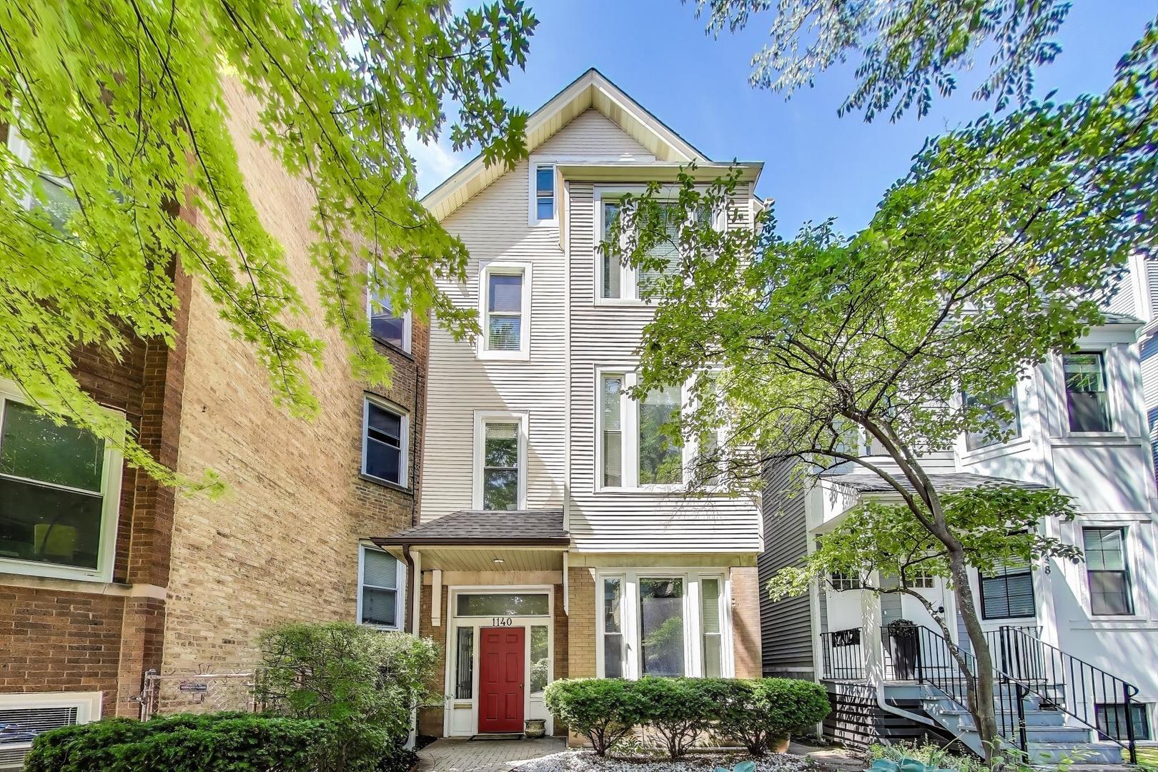 Welcome home to this bright and beautifully updated duplex up on a quiet, tree-lined street in Lakeview. This spacious layout is filled with natural light and features hardwood floors, large windows, and fresh paint throughout. The main level includes a generous living and dining area with plenty of room to relax or entertain. The remodeled kitchen features white upper and navy lower cabinetry, quartz countertops, stainless steel appliances, and a large walk-in pantry for extra storage. Also on this level is the spacious second bedroom with extra closet space and a full bath with a walk-in shower and updated tile, located just off the hallway. A private home office with a window and door offers the perfect work-from-home setup. Upstairs, the top-floor primary suite is a true retreat with vaulted ceilings, skylights, a walk-in closet, additional side closet storage, and an impressive amount of space-easily accommodating a full seating area, large desk, or offering endless possibilities for your ideal setup. The fully renovated en-suite bath features a warm wood vanity with quartz countertop, matte black fixtures, a soaking tub with sliding glass doors, vertical subway tile surround, modern hex tile flooring, a skylight, and a built-in linen cabinet. A separate laundry room near the back of the primary suite includes side-by-side washer and dryer, new patterned tile flooring, utility sink, and extra storage. Just off the kitchen, step outside to a private covered deck, perfect for morning coffee or grilling, and enjoy the fully fenced shared backyard with a brick paver patio and mature trees. Located in a well-maintained three-unit building with garage parking included. Easy access to restaurants, coffee shops, Whole Foods, Wrigley Field, public transit, and more in this prime Lakeview location!