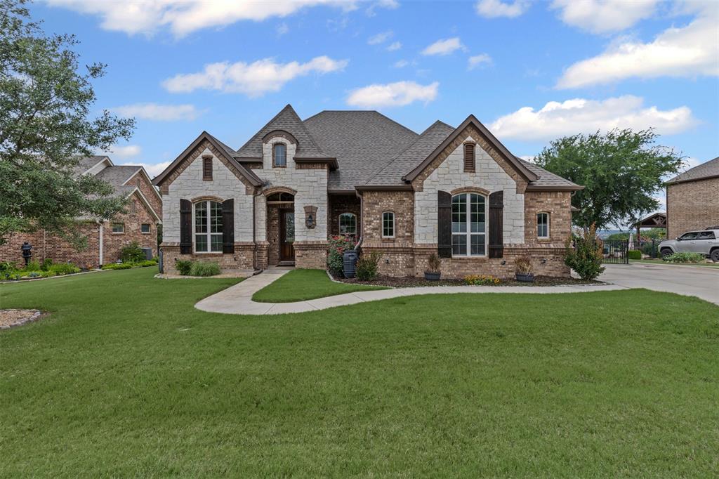 Absolutely stunning home in highly sought-after location, Resort on Eagle Mountain Lake! Berber carpet, tile flooring, hand-scraped hardwood flooring, art niche, transom at front door, bay of windows overlooking backyard, covered porch & patio, landscaping, wrought iron fencing, 3 car garage, water softener, dual vanity in primary bathroom with sunken tub & walk-in tile shower with rainhead & body spray jets, walk-in closet, custom cabinetry, extensive, custom millwork throughout, exterior door from garage, recessed lighting, plantation shutters, custom, bullnose drywall, solar shades, dark out shades at media room, raised ceilings throughout,coffered ceilings, triple crown molding, built in kitchen with granite countertops, island, breakfast bar, sprinkler system, corner propane fireplace with raised stone & brick hearth & wood mantel, outdoor kitchen.
