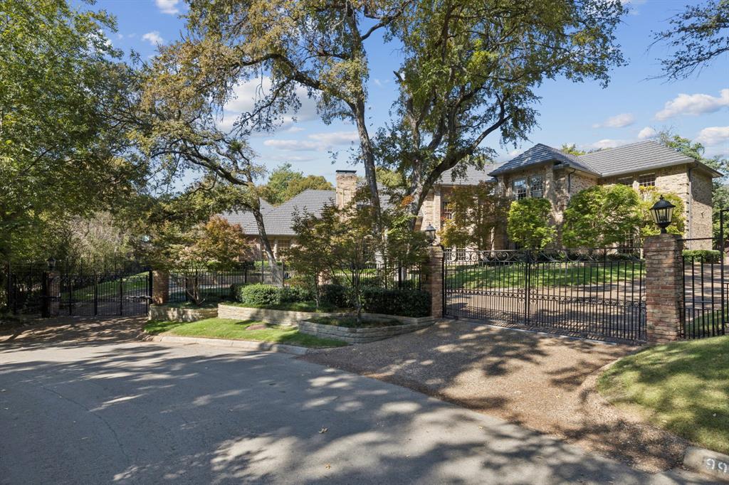 Set along the winding cul-de-sac of Strait Lane, this enduring traditional residence offers approximately 7,546 square feet on an expansive .910-acre lot, framed by mature trees and lush landscaping. A coveted Preston Hollow address, the property is fully enclosed by perimeter fencing, including dual electric gates at the front entry and a custom fiber privacy fence at the rear. Soaring ceilings in the formal living and dining rooms set a gracious tone upon entry, while the first-floor family room showcases rich millwork and refined craftsmanship. The chef's kitchen features stainless steel appliances, a Sub-Zero refrigerator, double dishwashers, wine refrigeration, and an oversized island with double drink refrigerator drawers, all overlooking the breakfast nook and verdant backyard. The primary suite is privately positioned in its own wing, featuring a fireplace, spa-inspired bath, generous closet, and dry sauna. An adjacent bedroom with a wet bar offers flexibility as a study, nursery, or guest suite. The intelligently designed floor plan includes six bedrooms, six full baths, a media room, exercise room, and a third-floor playroom or extra flex living space. Designed for elegant entertaining, the grounds showcase a pool and spa, a sweeping lawn, a multi-use sport court with pickleball striping, a custom resurfaced patio, architectural landscape lighting, and a four-car garage. Recent improvements include a 2020 metal shake roof with fresh decking, gutters, downspouts, a skylight, and chimney caps; upgraded insulation; Control4 theater and audio; a 2025 furnace and hot water unit; updated alarm wiring and panels; and refreshed interior and exterior paint. 9941 Strait Lane presents a rare opportunity to own scale, privacy, and pedigree on one of Dallas' most distinguished streets.